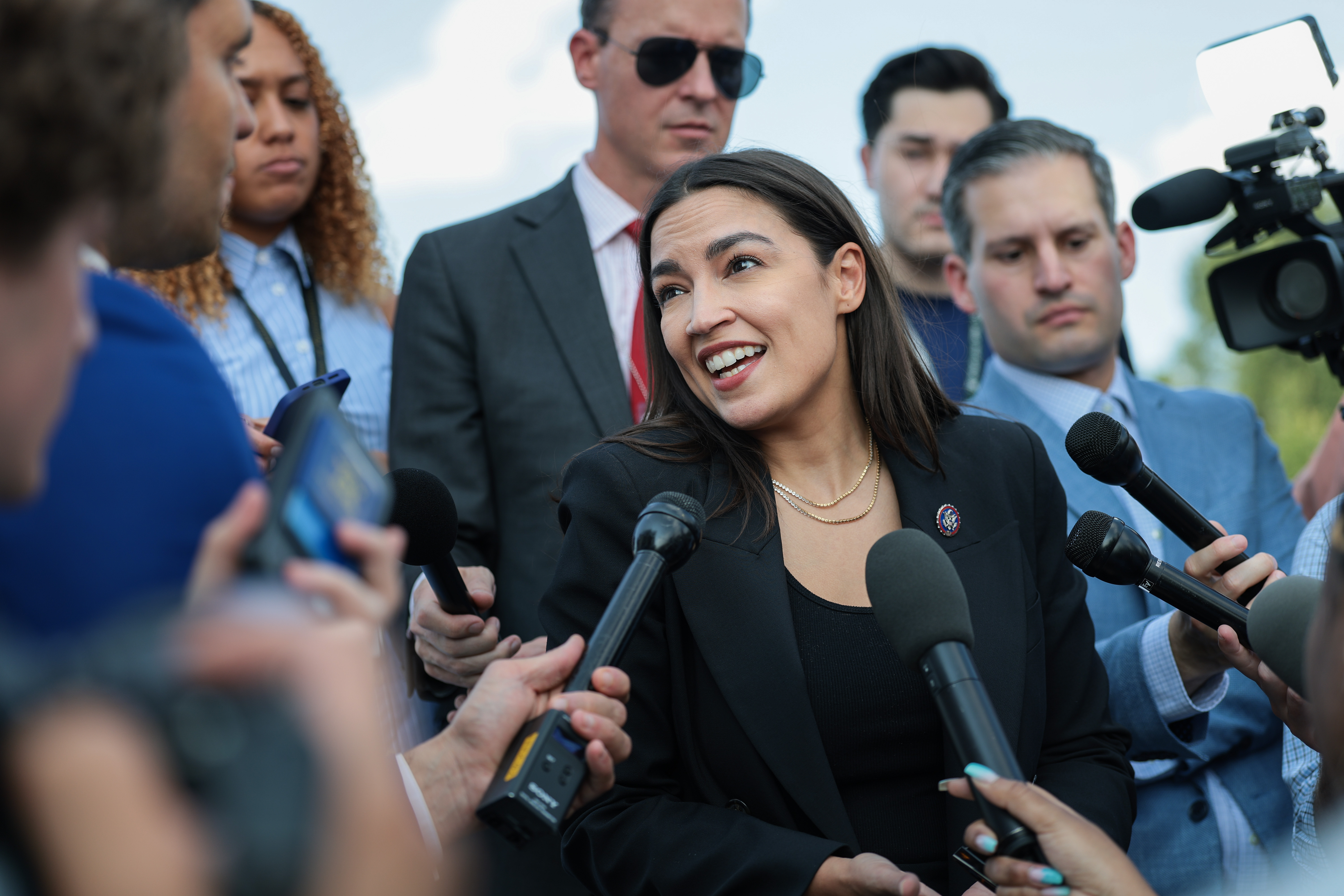 Alexandria Ocasio-Cortez speaking to reporters near the House steps at the U.S. Capitol