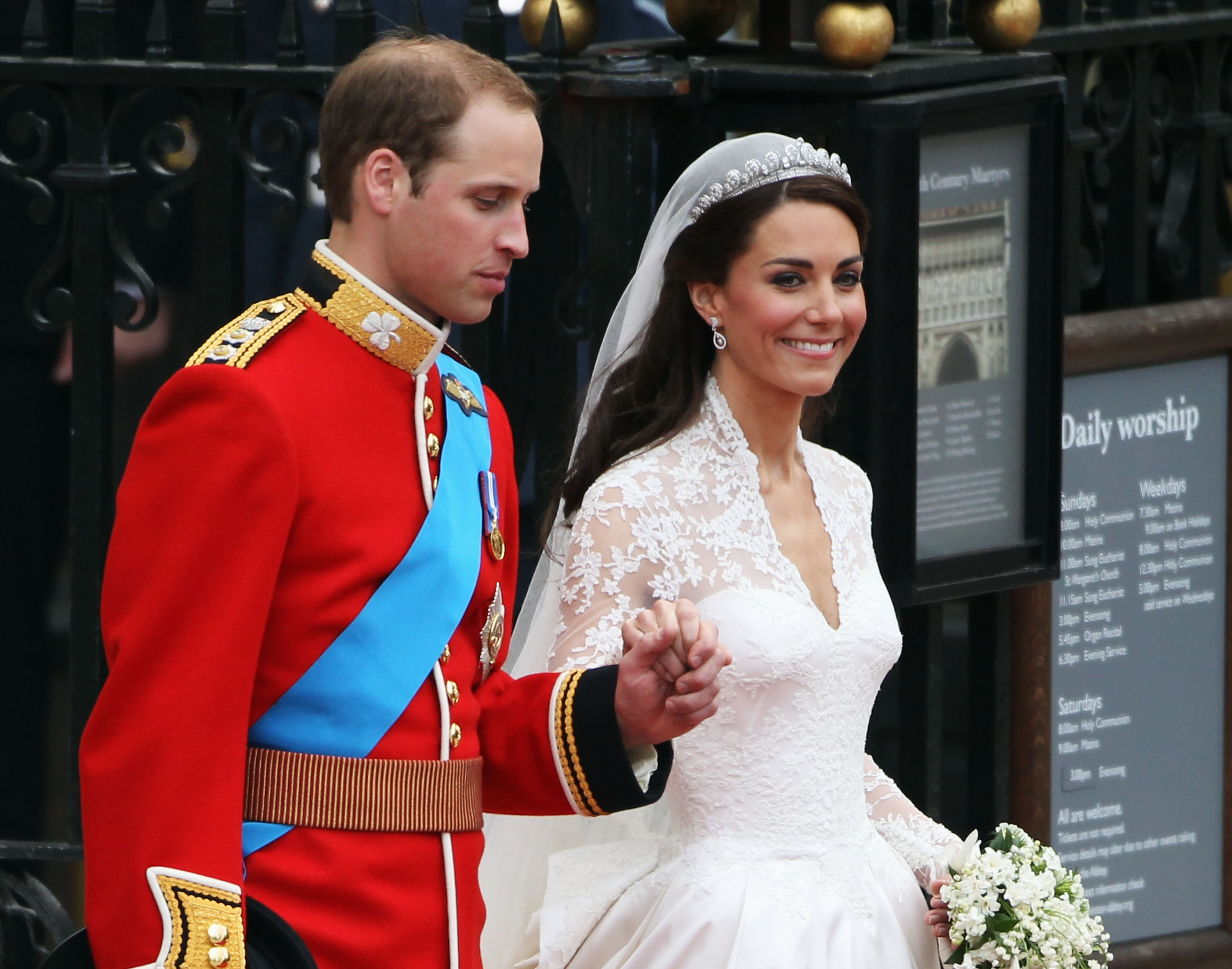 Prince William and Catherine, Duchess of Cambridge, riding in a carriage procession to Buckingham Palace on their wedding day in London