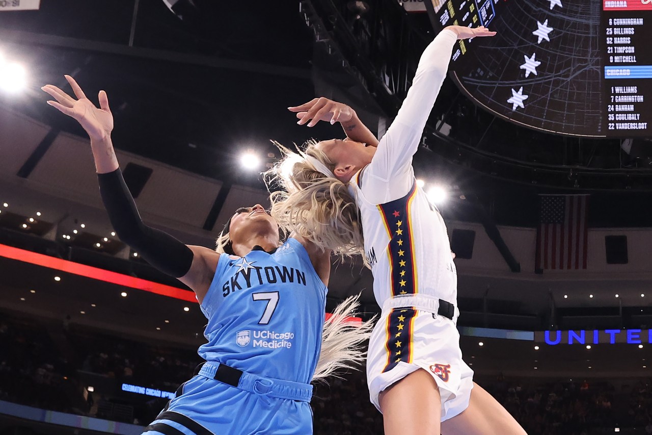 Chicago Sky's DiJonai Carrington (#7) fouls Indiana Fever's Sophie Cunningham (#8) with a forearm to the face during a drive to the basket.