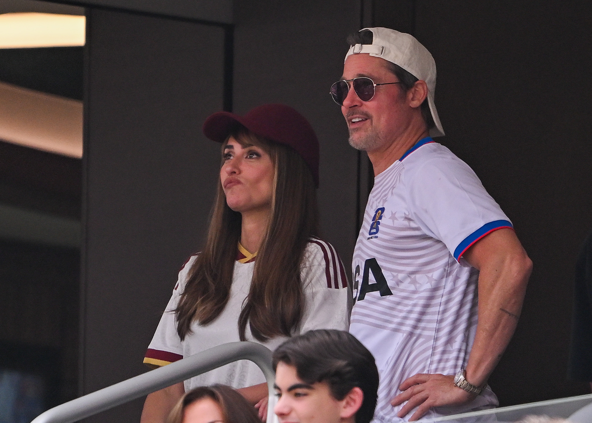 Brad Pitt and Penelope Cruz seated together at the FIFA World Cup 2026 quarterfinal match between Spain and Belgium at Los Angeles Stadium