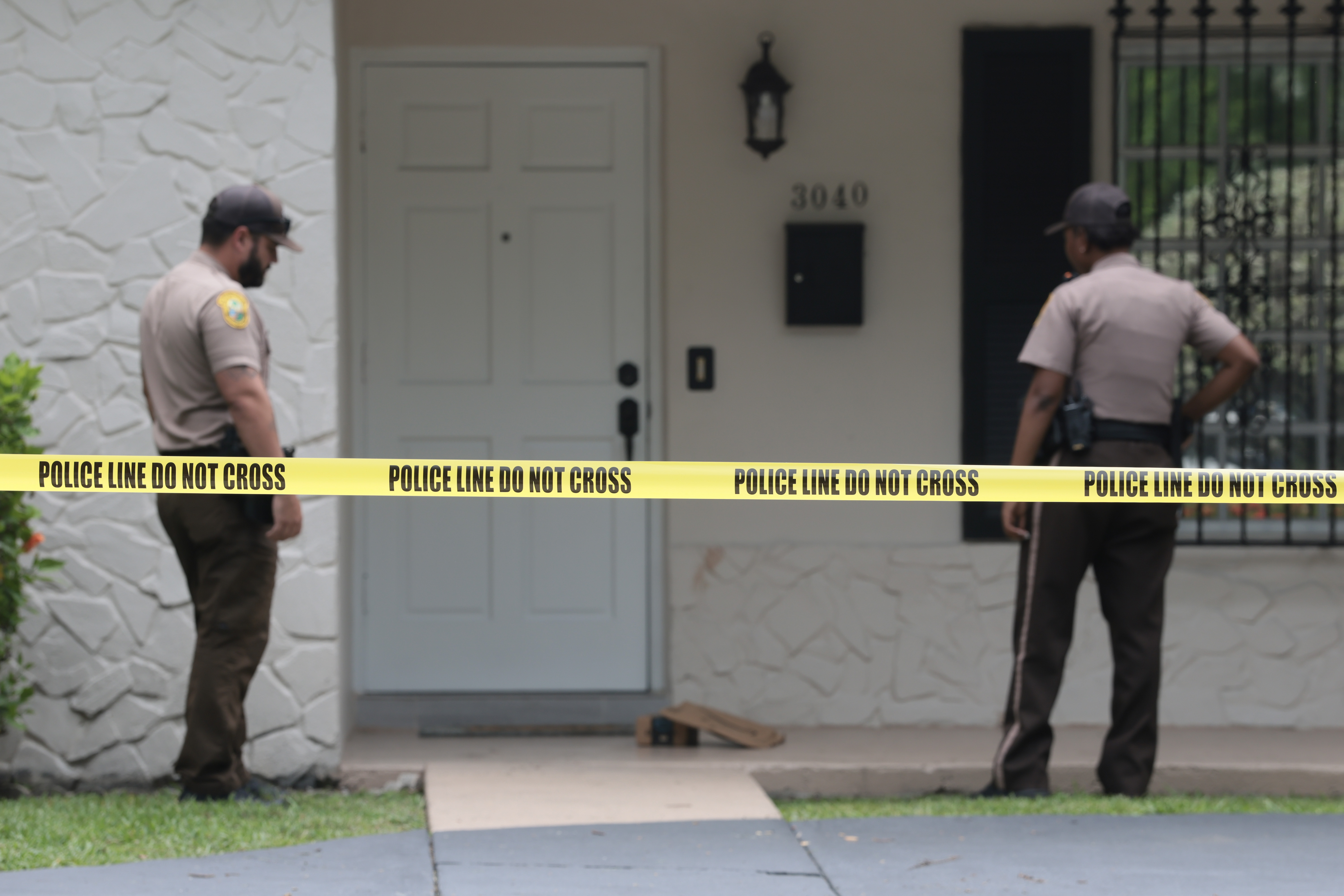 Miami-Dade County Sheriff's deputies standing outside a home in Westchester, Florida
