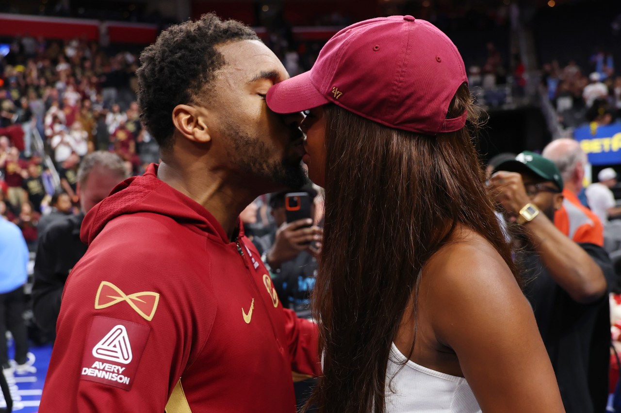 Donovan Mitchell and Coco Jones kissing on the court at Little Caesars Arena after Game Seven of the NBA playoffs