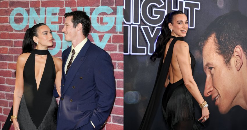 Dua Lipa in a black halter gown and Callum Turner in a navy suit smile at each other at the One Night Only premiere in New York.