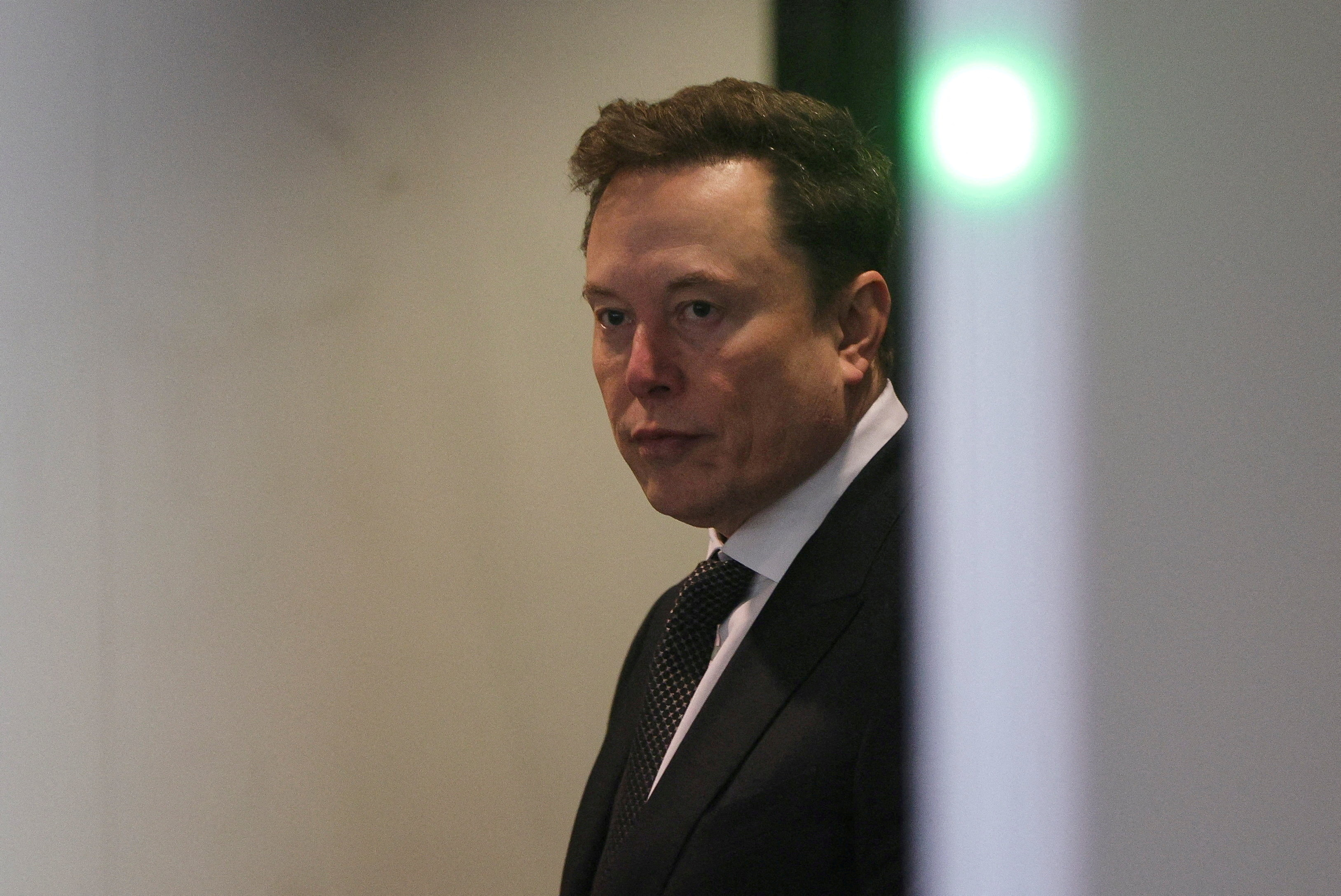 Elon Musk walking toward a federal courthouse in Oakland, California