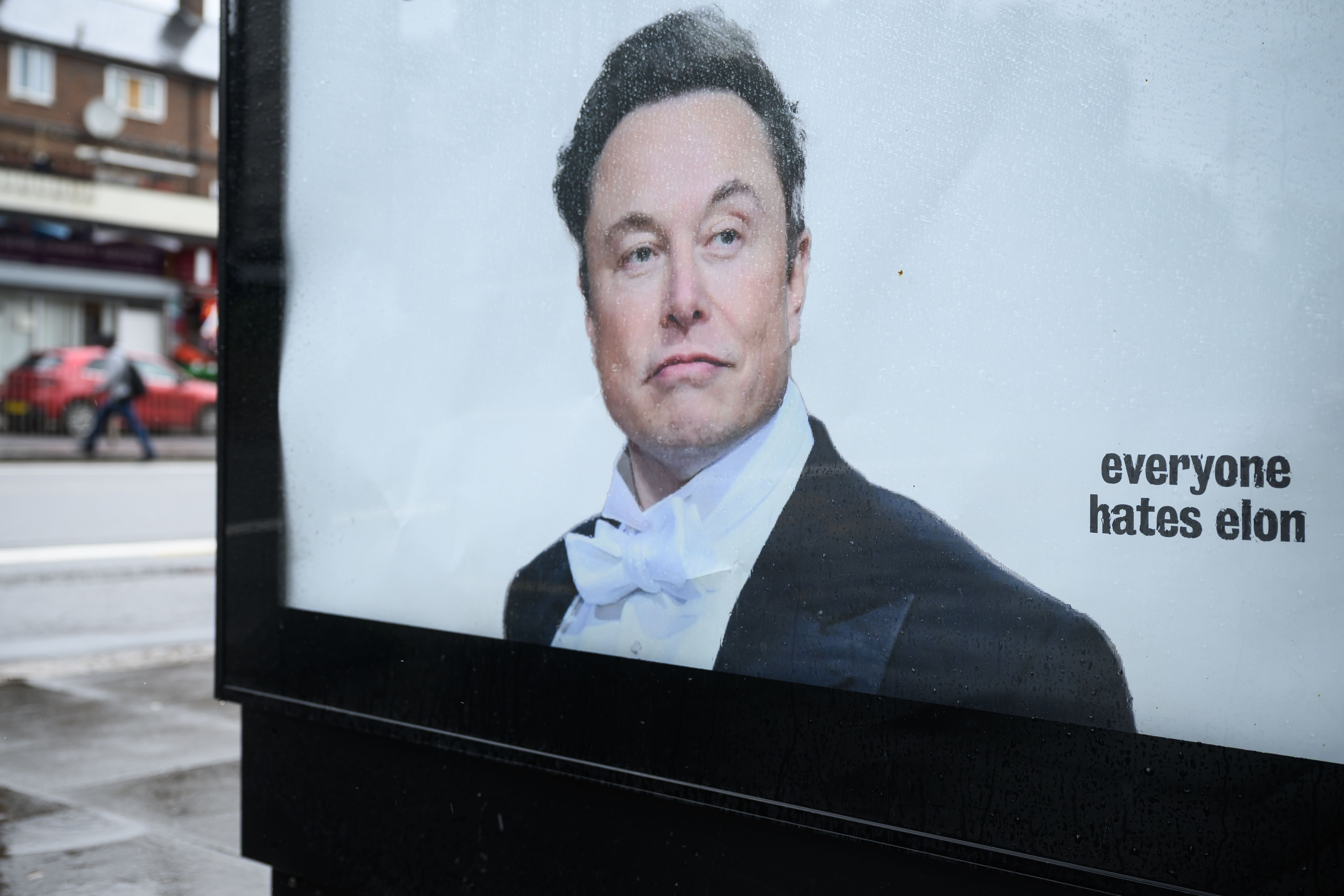 An anti-Elon Musk poster affixed to a bus shelter in Tottenham, North London, criticizing his wealth