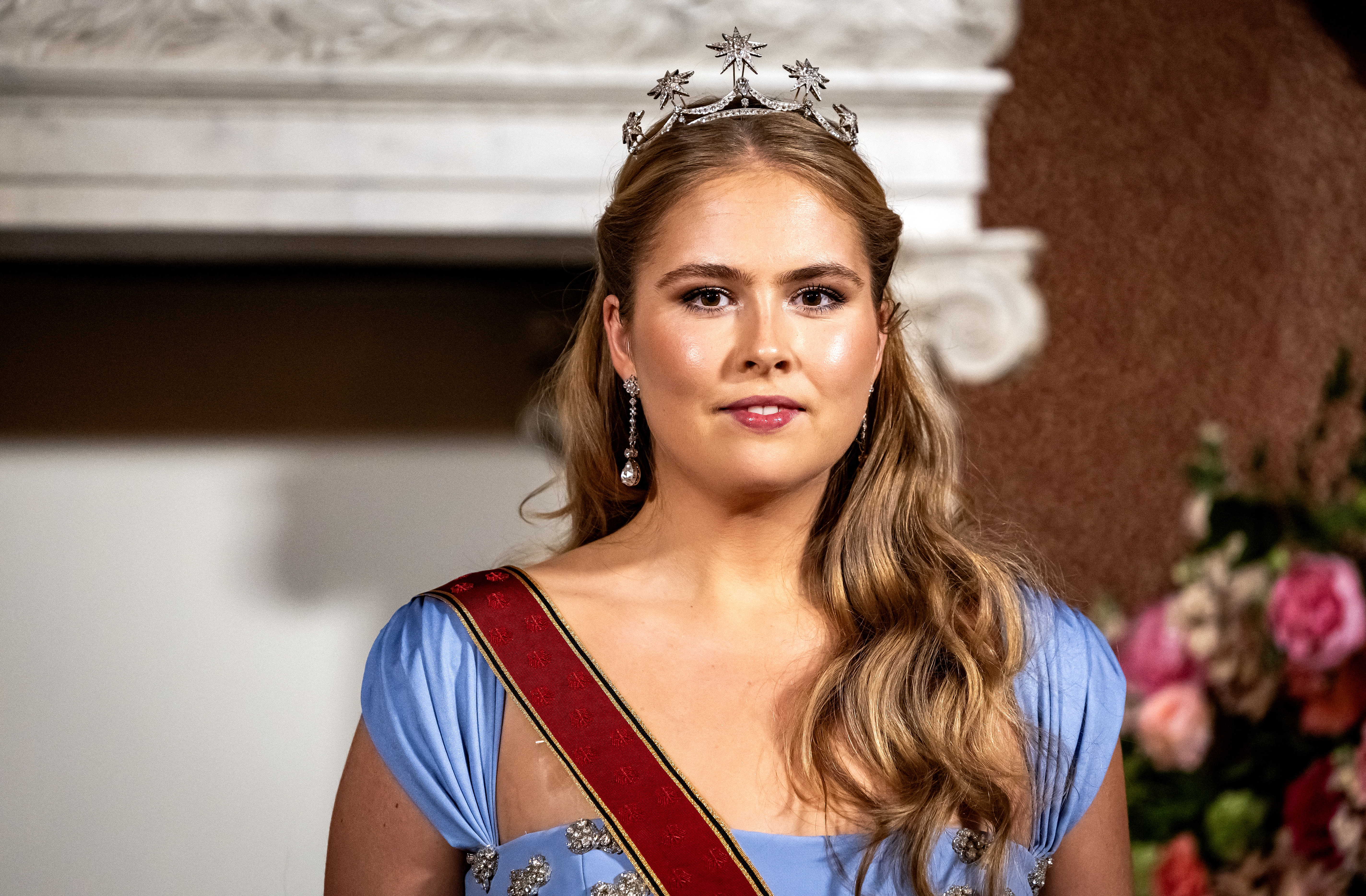 Princess Amalia of the Netherlands standing at the Royal Palace in Amsterdam before a state banquet