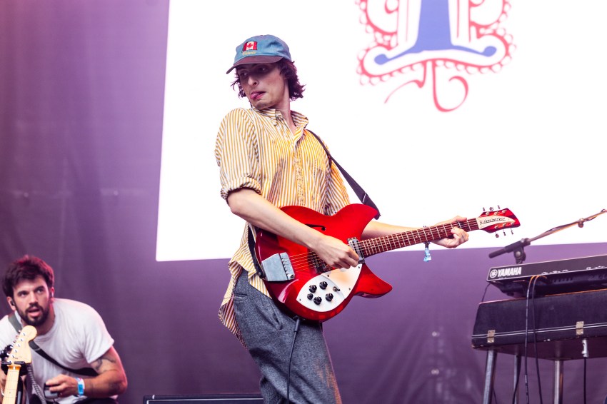 Finn Wolfhard performing on stage at Lollapalooza in Grant Park, Chicago