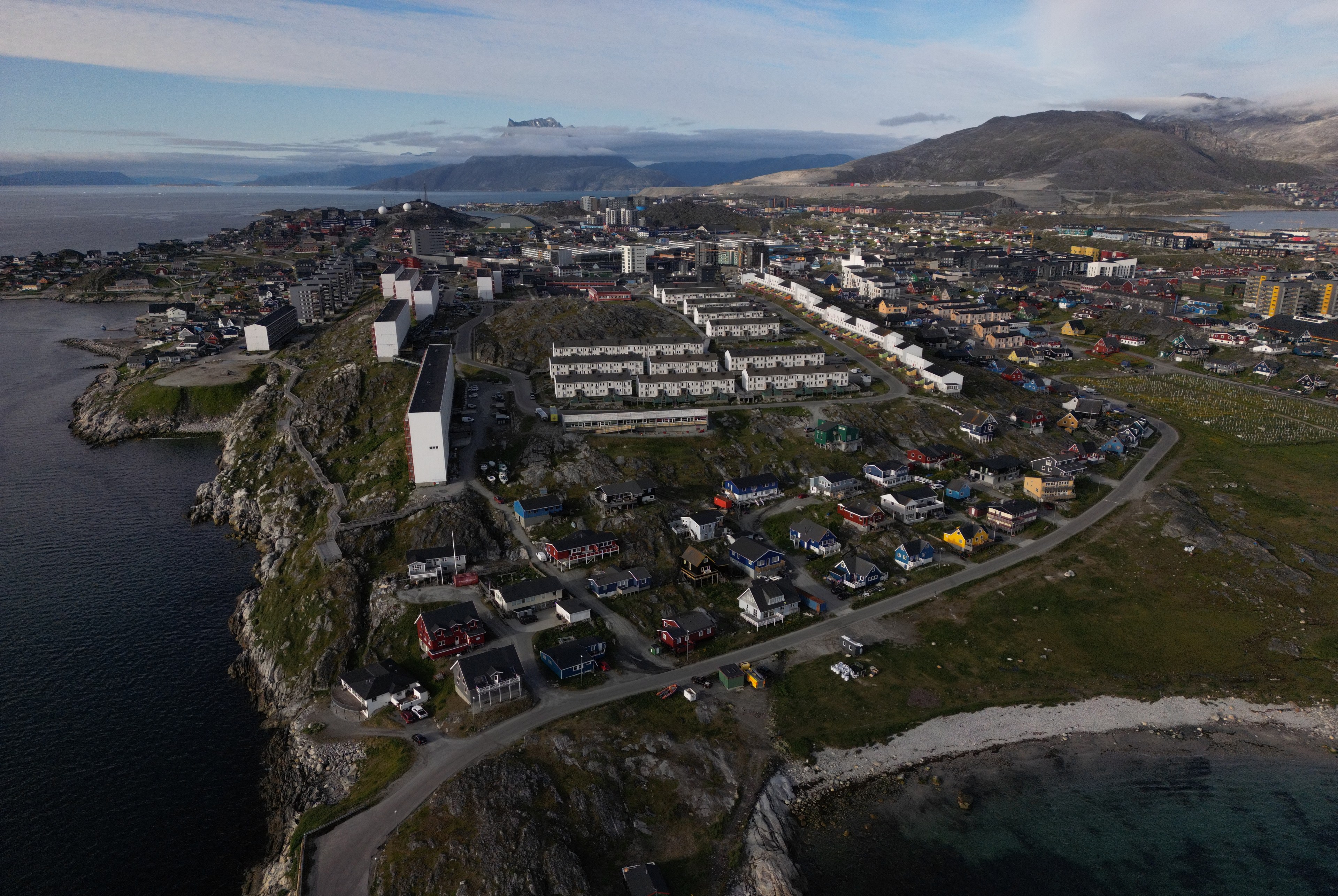 Aerial view of houses and apartment buildings along the shoreline in Nuuk, Greenland