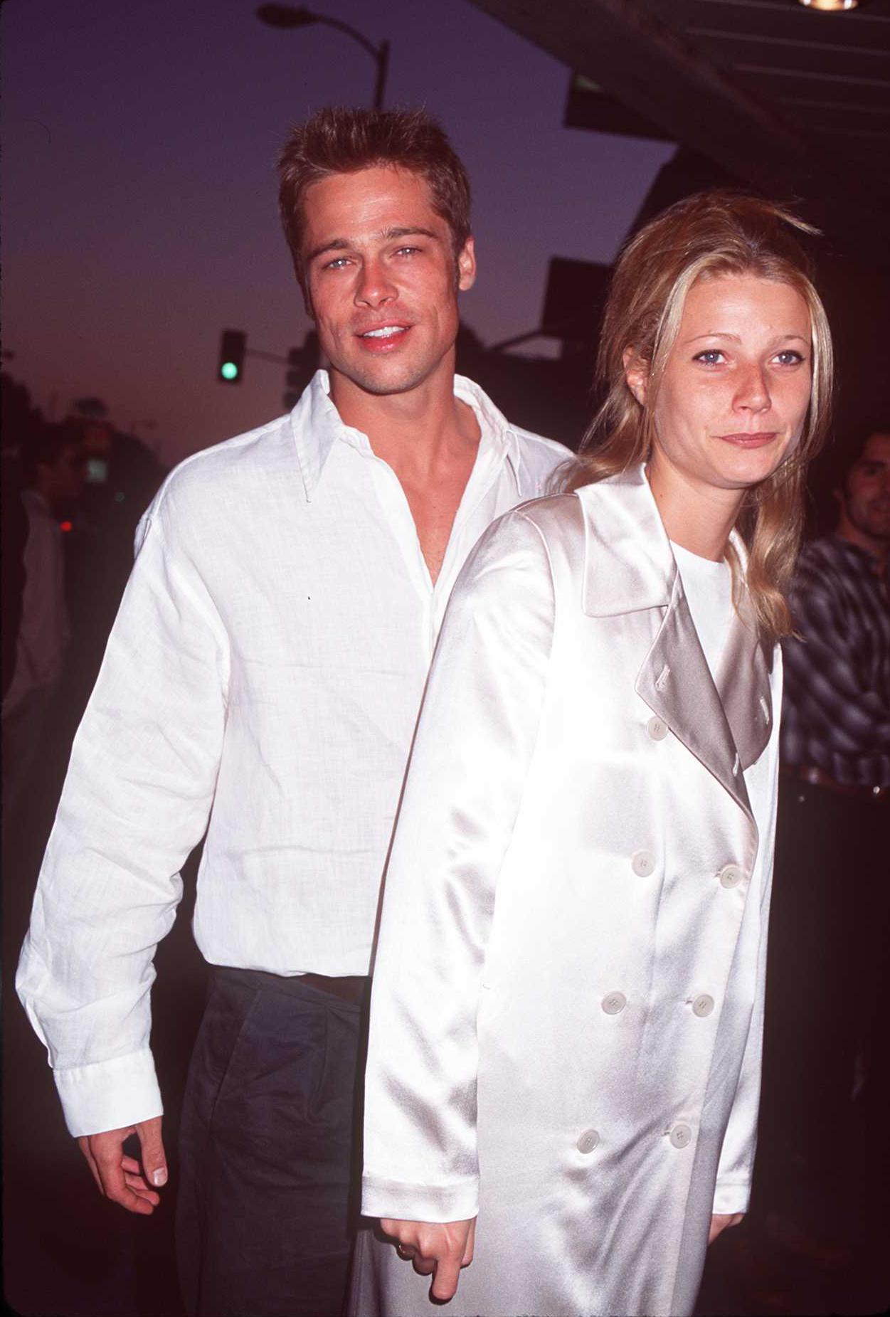 Brad Pitt in a white shirt and Gwyneth Paltrow in a white satin coat at a movie premiere in Los Angeles, 1995.