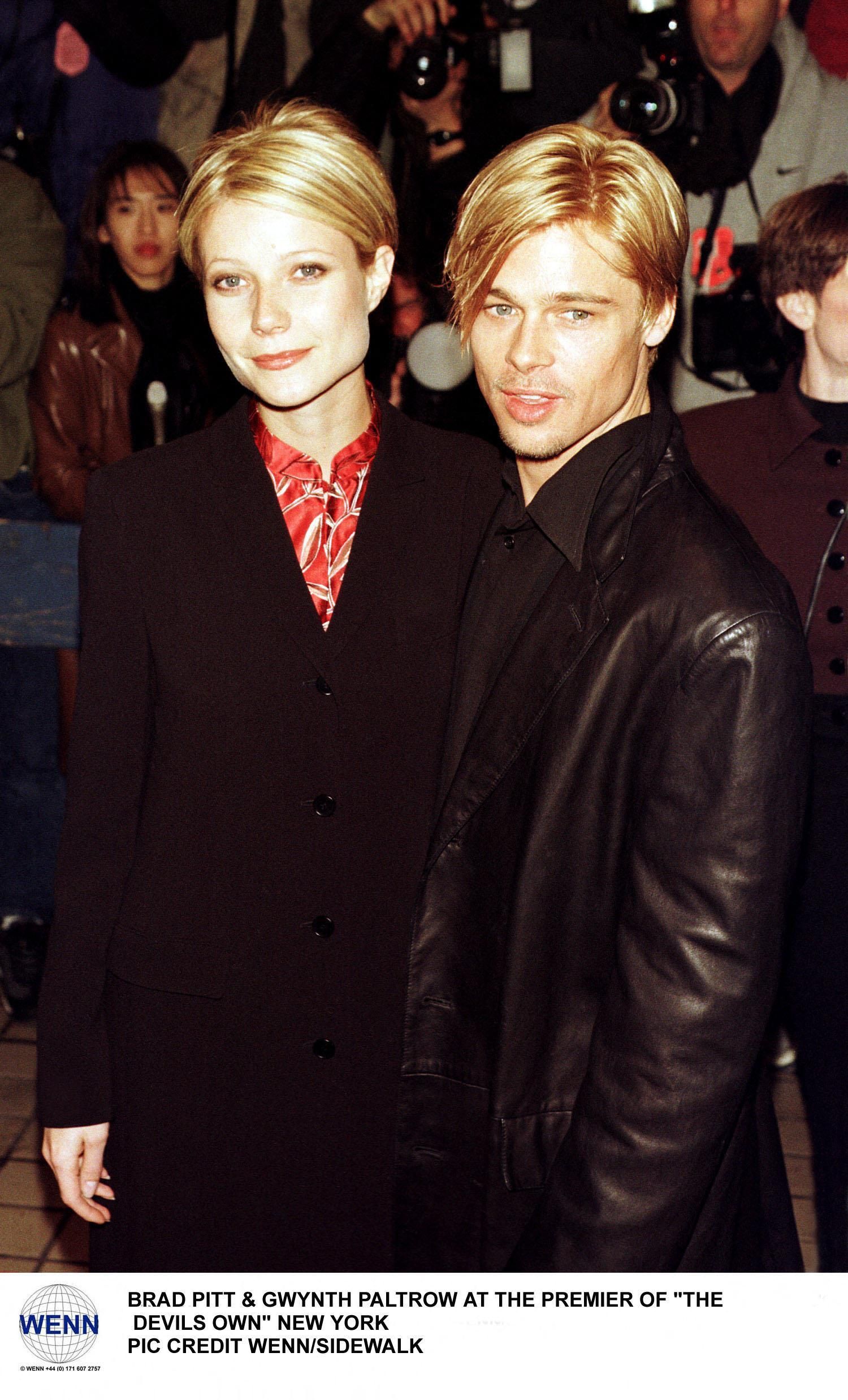 Gwyneth Paltrow in a black blazer with red shirt and Brad Pitt in a leather jacket at a New York movie premiere, 1997.