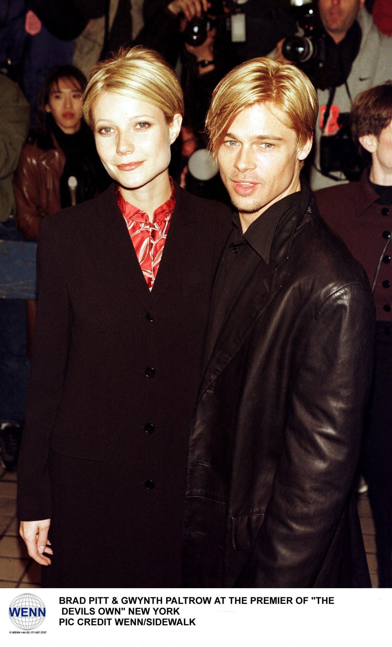 Gwyneth Paltrow in a black blazer with red shirt and Brad Pitt in a leather jacket at a New York movie premiere, 1997.