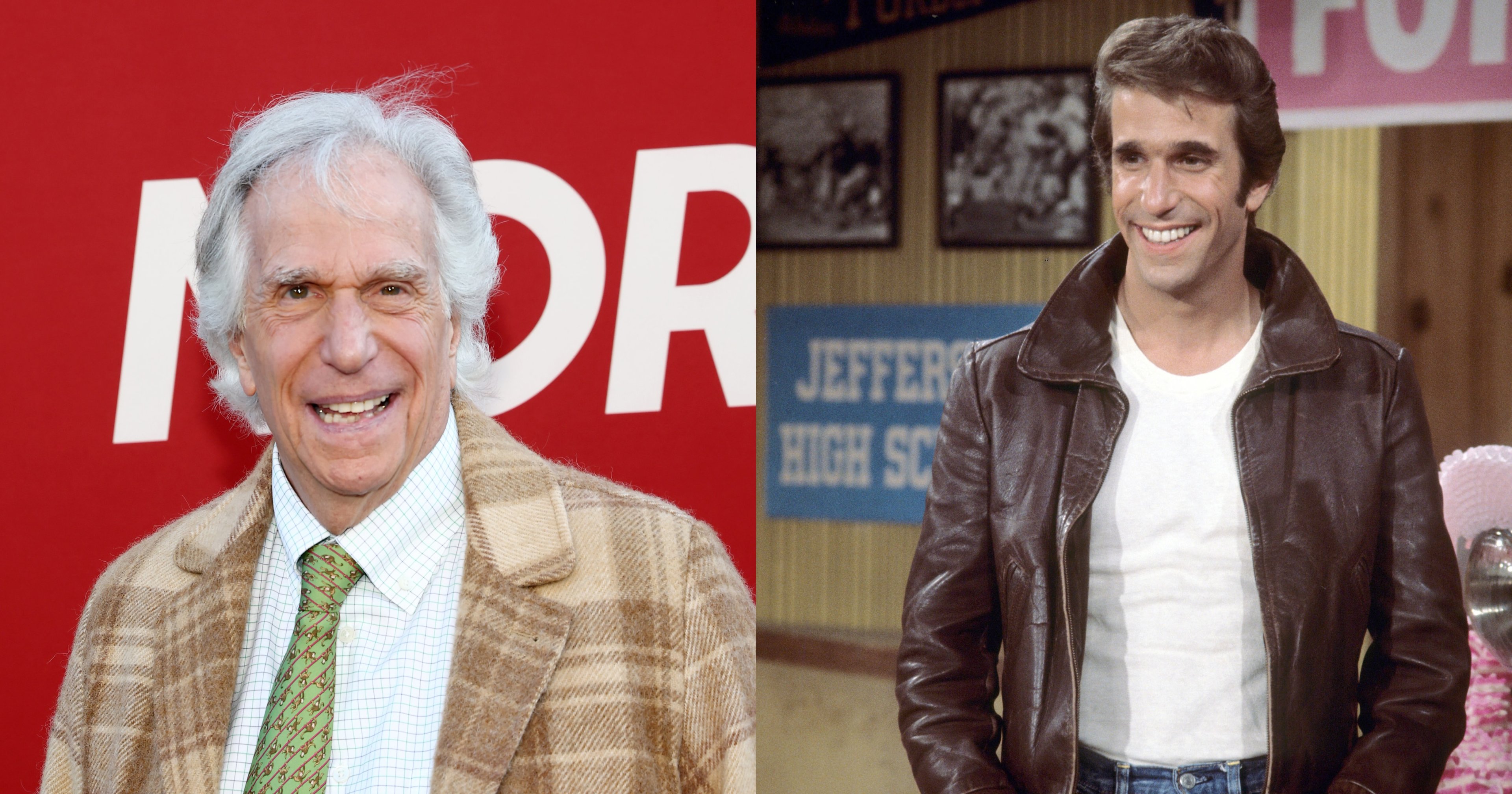 Henry Winkler smiling in a tan plaid blazer and green tie at a red backdrop event.