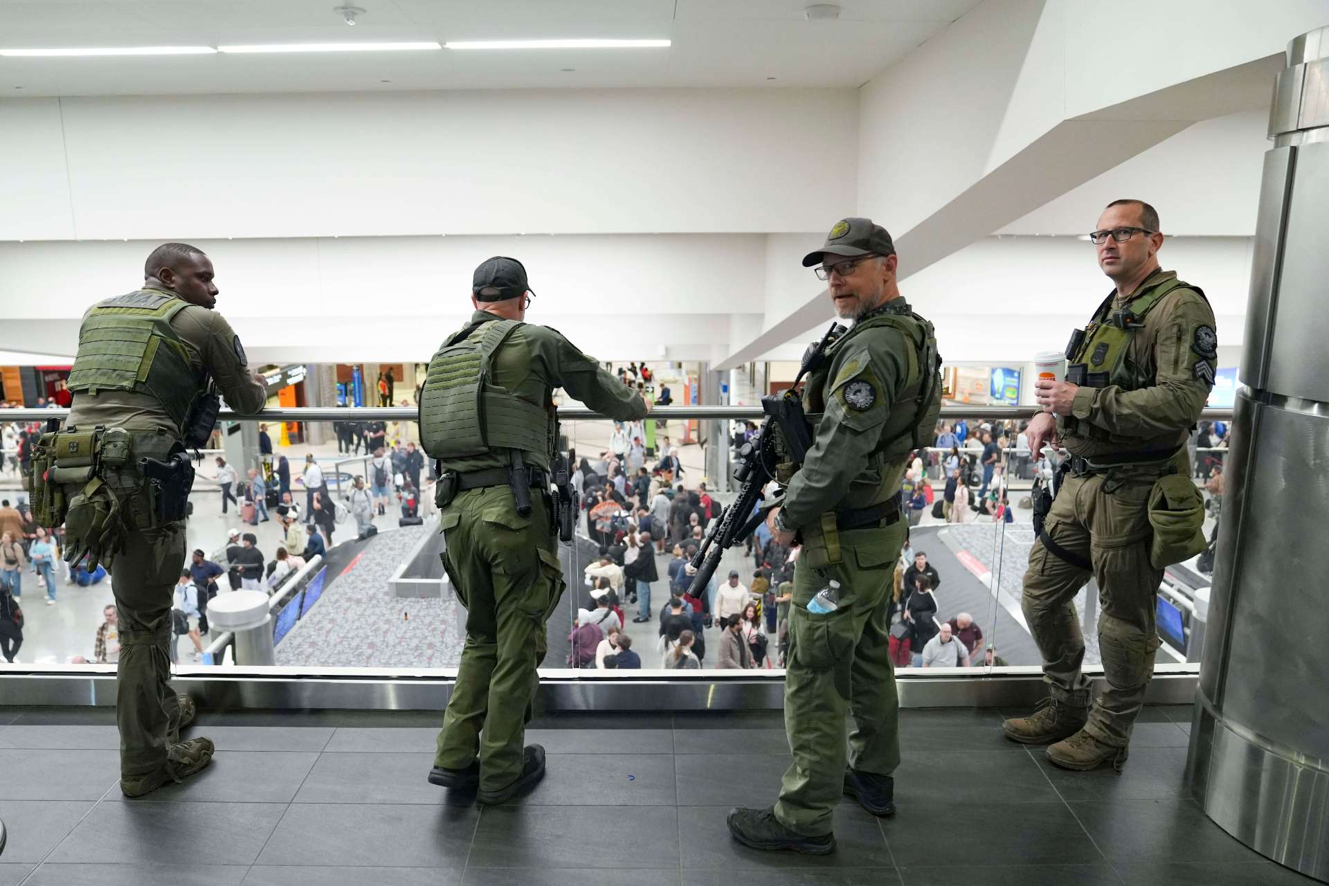 Atlanta Police officers watch as travelers stand in long lines at Hartsfield-Jackson International Airport in Atlanta, Georgia.