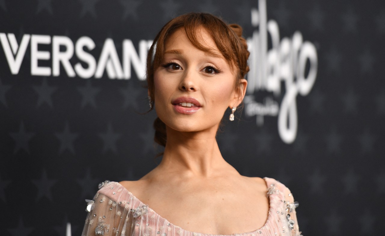 Ariana Grande with auburn updo and bangs in a blush embellished dress at the Critics Choice Awards.