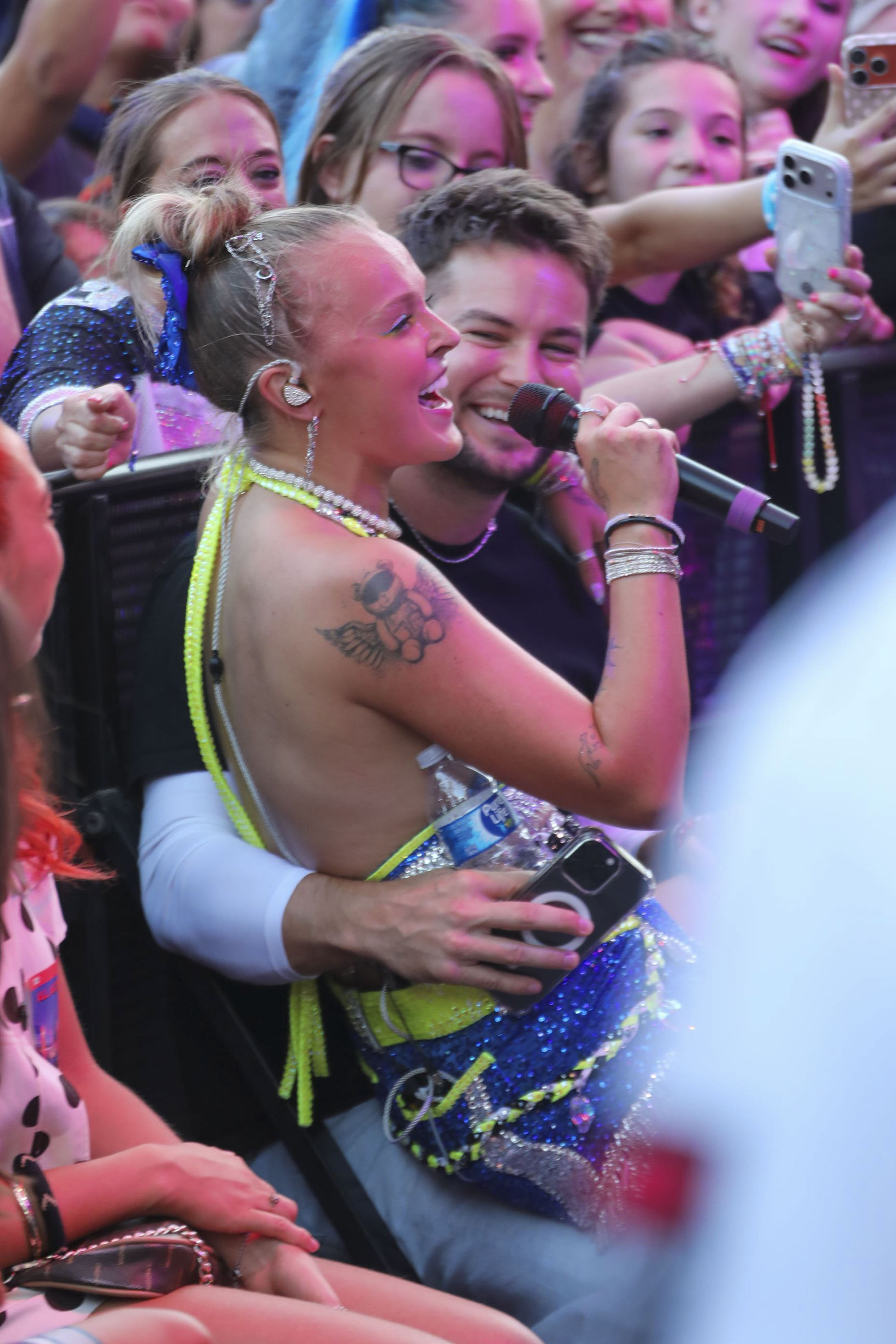 JoJo Siwa sits on boyfriends Chris Hughes lap while she performs live at Universal CityWalk in Los Angeles