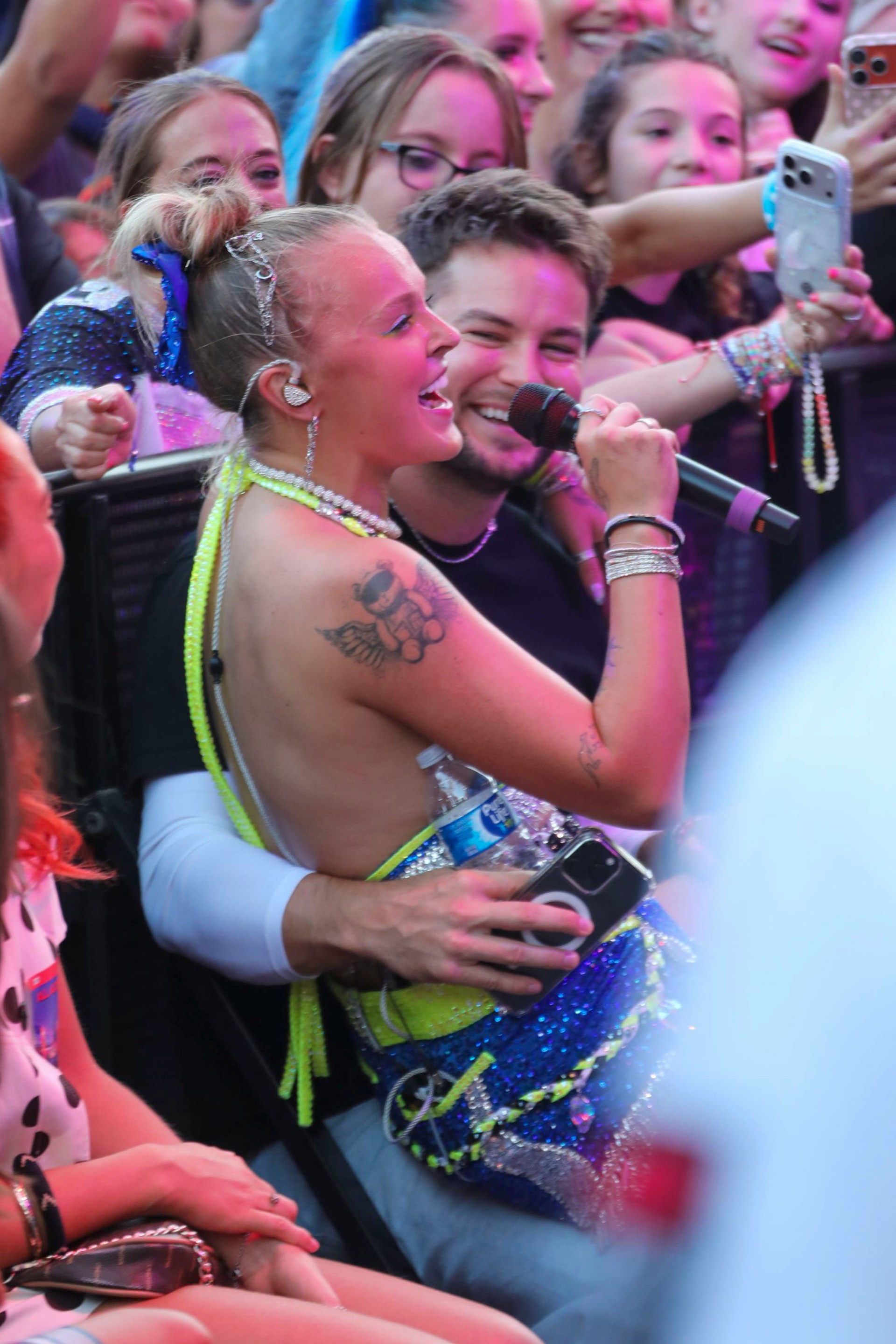 JoJo Siwa sits on boyfriends Chris Hughes lap while she performs live at Universal CityWalk in Los Angeles