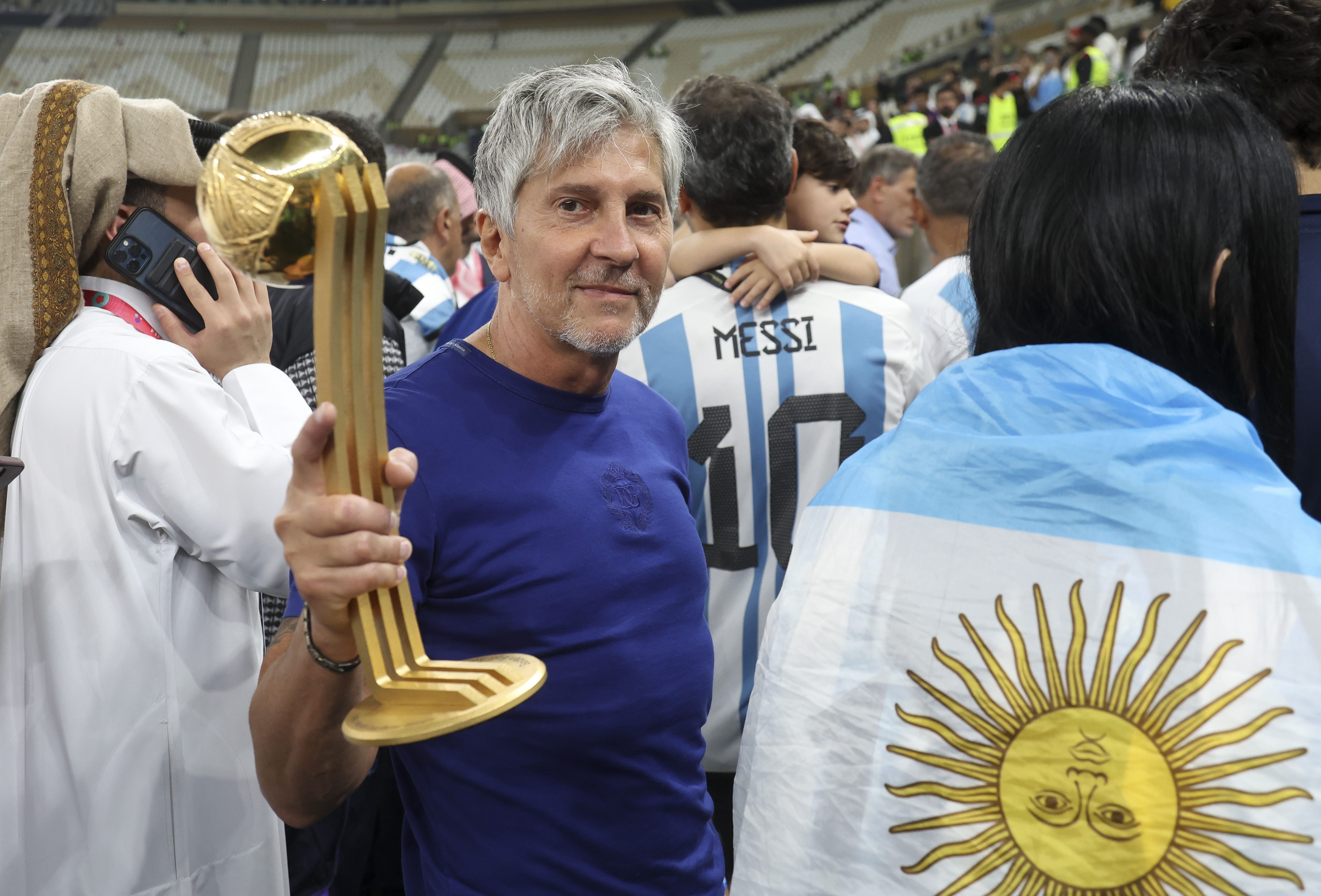 Jorge Messi holding his son Lionel Messi's Best Player of the World Cup trophy at Lusail Stadium in Qatar