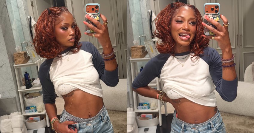 Woman with auburn braids takes a mirror selfie in a bathroom, wearing a cropped baseball tee and low-rise denim shorts.