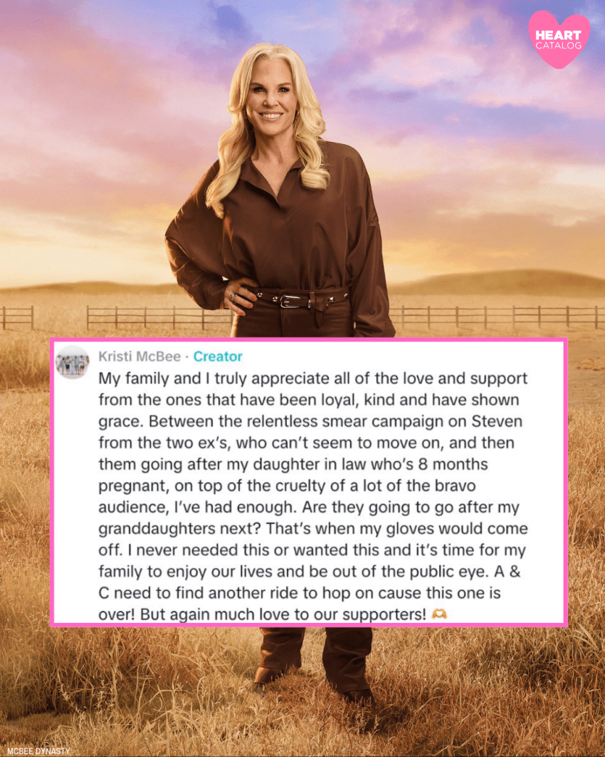 Blonde woman in a brown silk shirt, brown pants, and brown boots standing in a golden grass field with a fence and colorful sunset sky behind her.