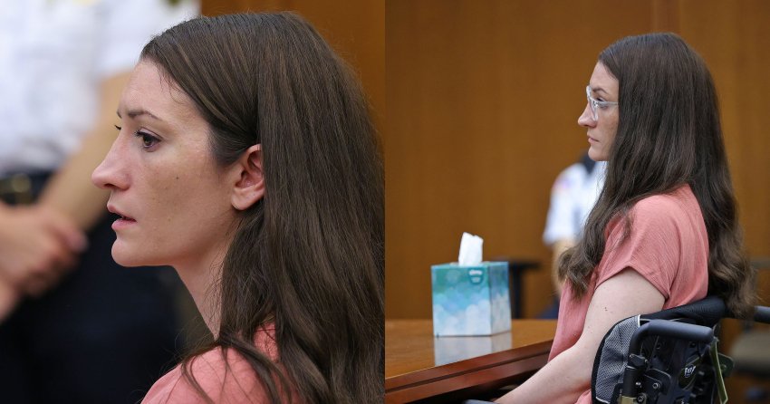 Woman with long dark hair in a pink shirt seated in a courtroom, looking to the side, with a uniformed officer visible in the background.