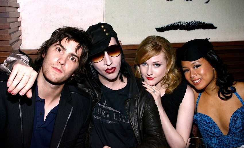 Four people seated at a booth: Jim Sturgess, Marilyn Manson in sunglasses and a black cap, Evan Rachel Wood, and T.V. Carpio in a blue dress.