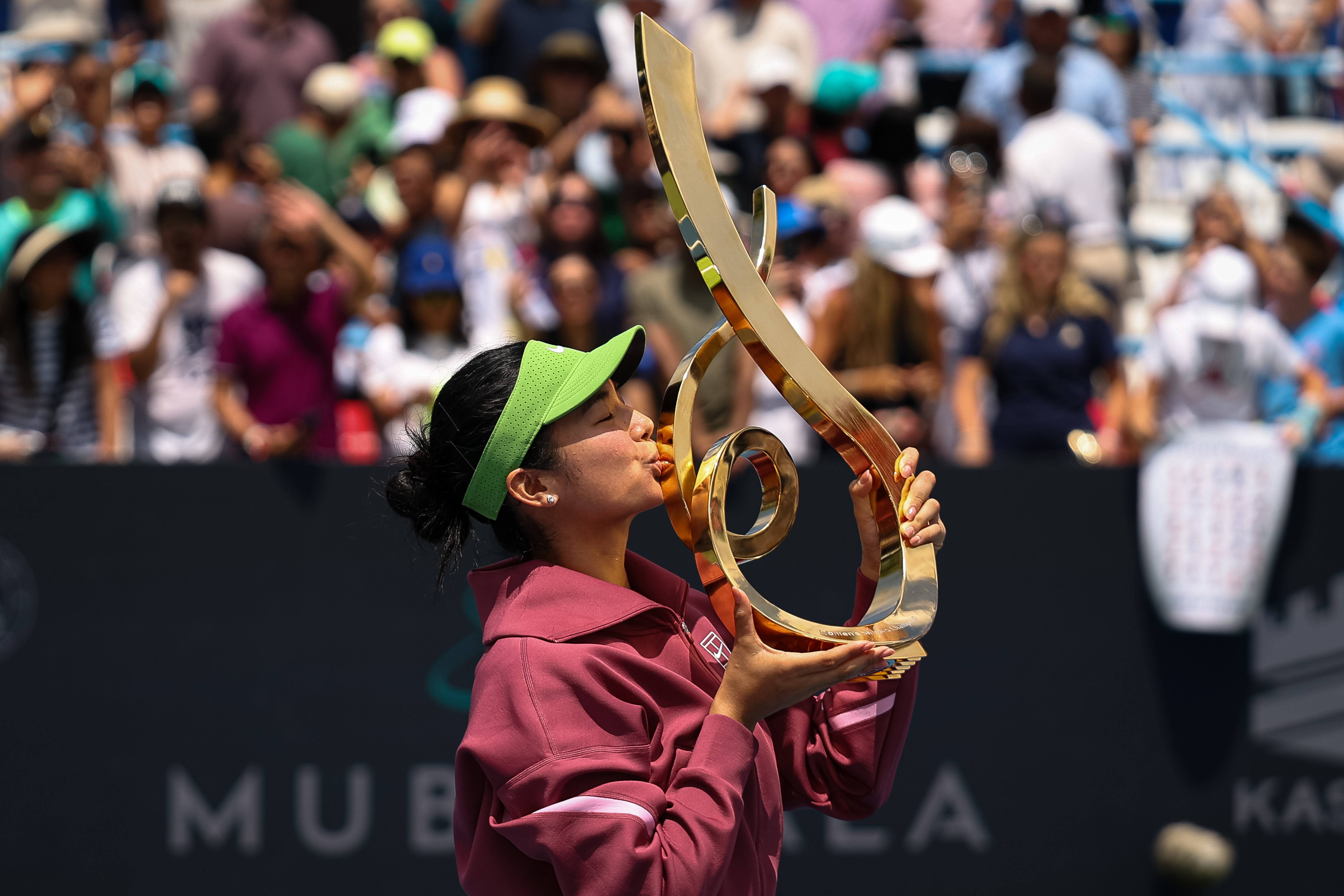 Alexandra Eala kissing the Championship Trophy after winning the Mubadala DC Open 2026 women's singles final