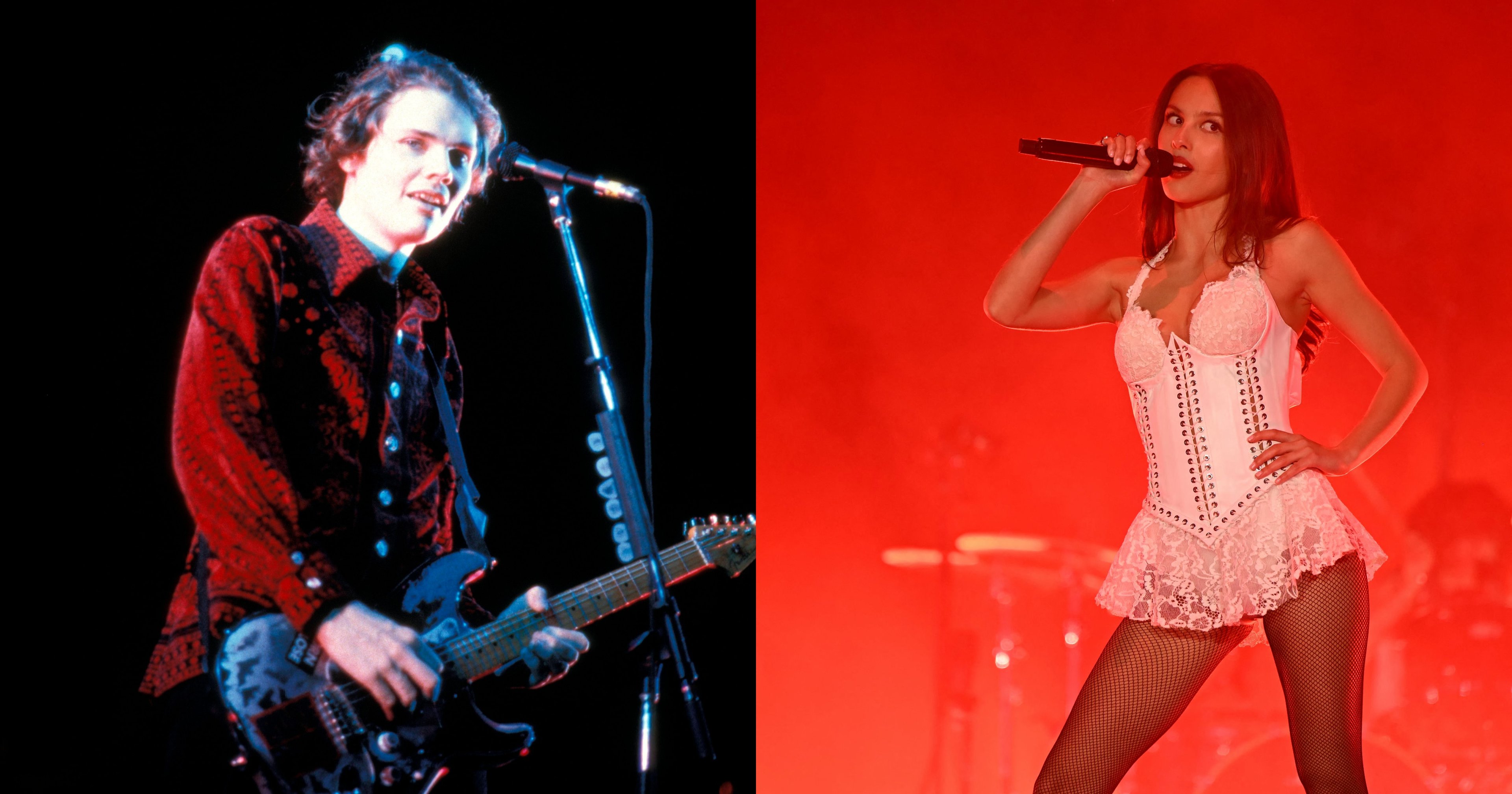 A young male guitarist in a red patterned shirt plays an electric guitar at a microphone stand on a darkened stage.