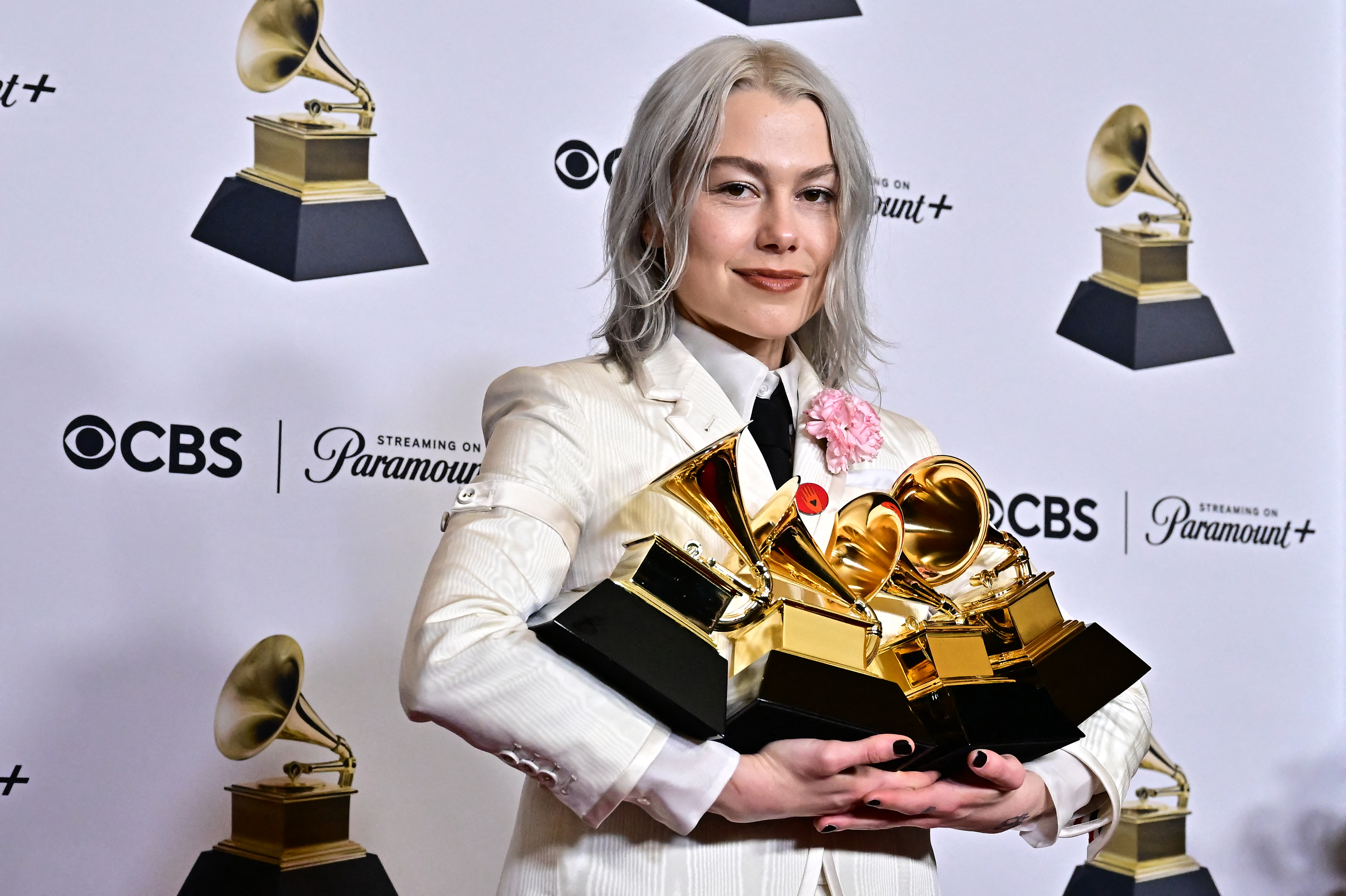 Phoebe Bridgers holding four Grammy Awards in the press room at the 66th Annual Grammy Awards in Los Angeles