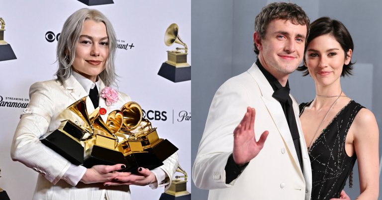 Phoebe Bridgers in a white suit holding four Grammy Awards in front of a CBS and Paramount+ step-and-repeat backdrop.