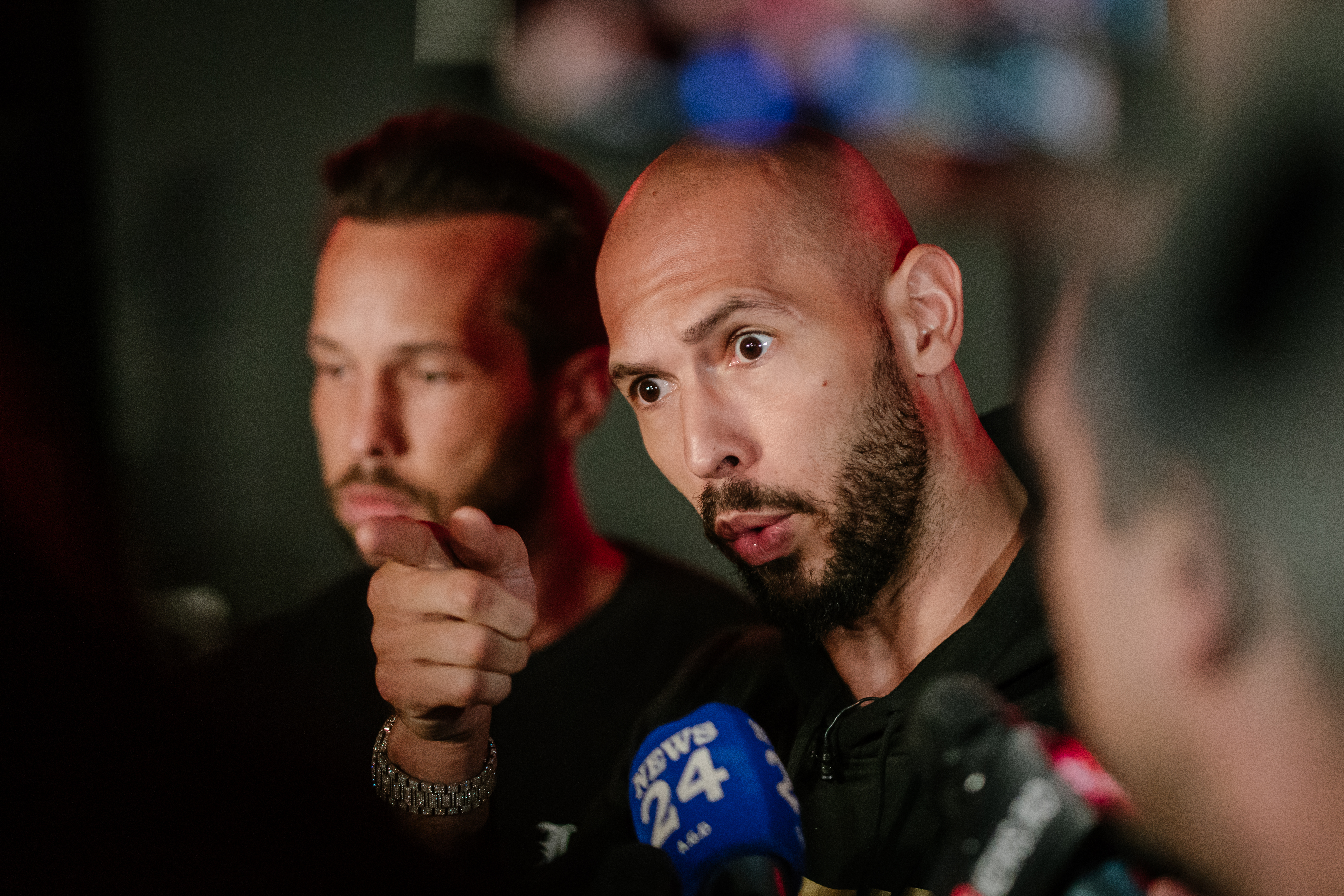 Andrew Tate and Tristan Tate speaking to media outside their residence in Bucharest, Romania