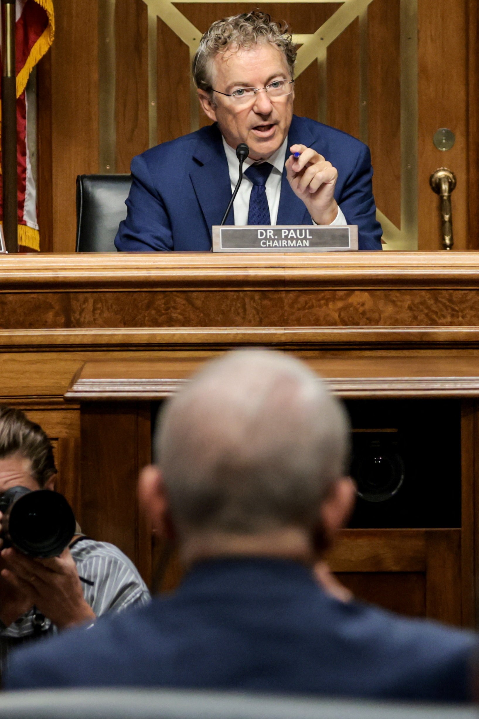 Anthony Fauci seated at a Senate committee hearing on Capitol Hill as Rand Paul speaks