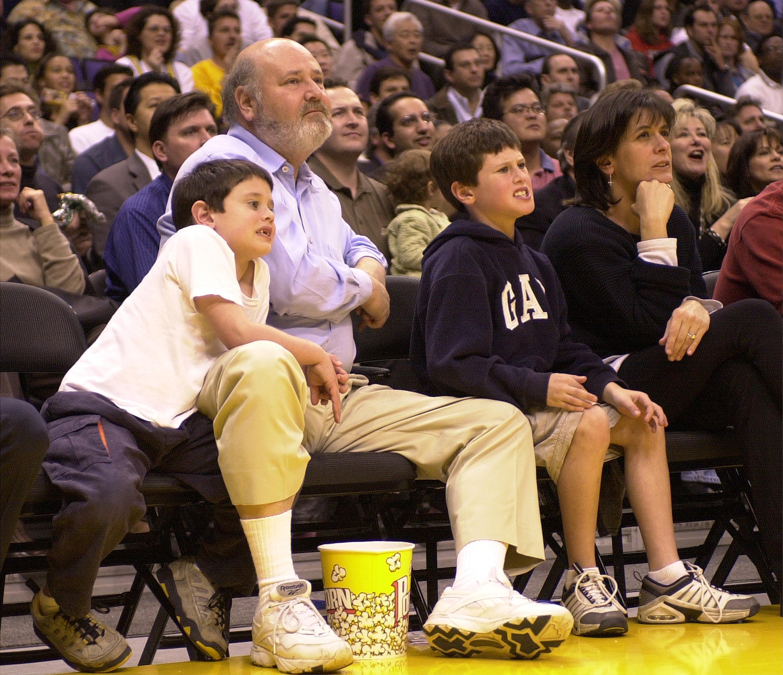 Rob Reiner and his family watching a basketball game courtside in Los Angeles