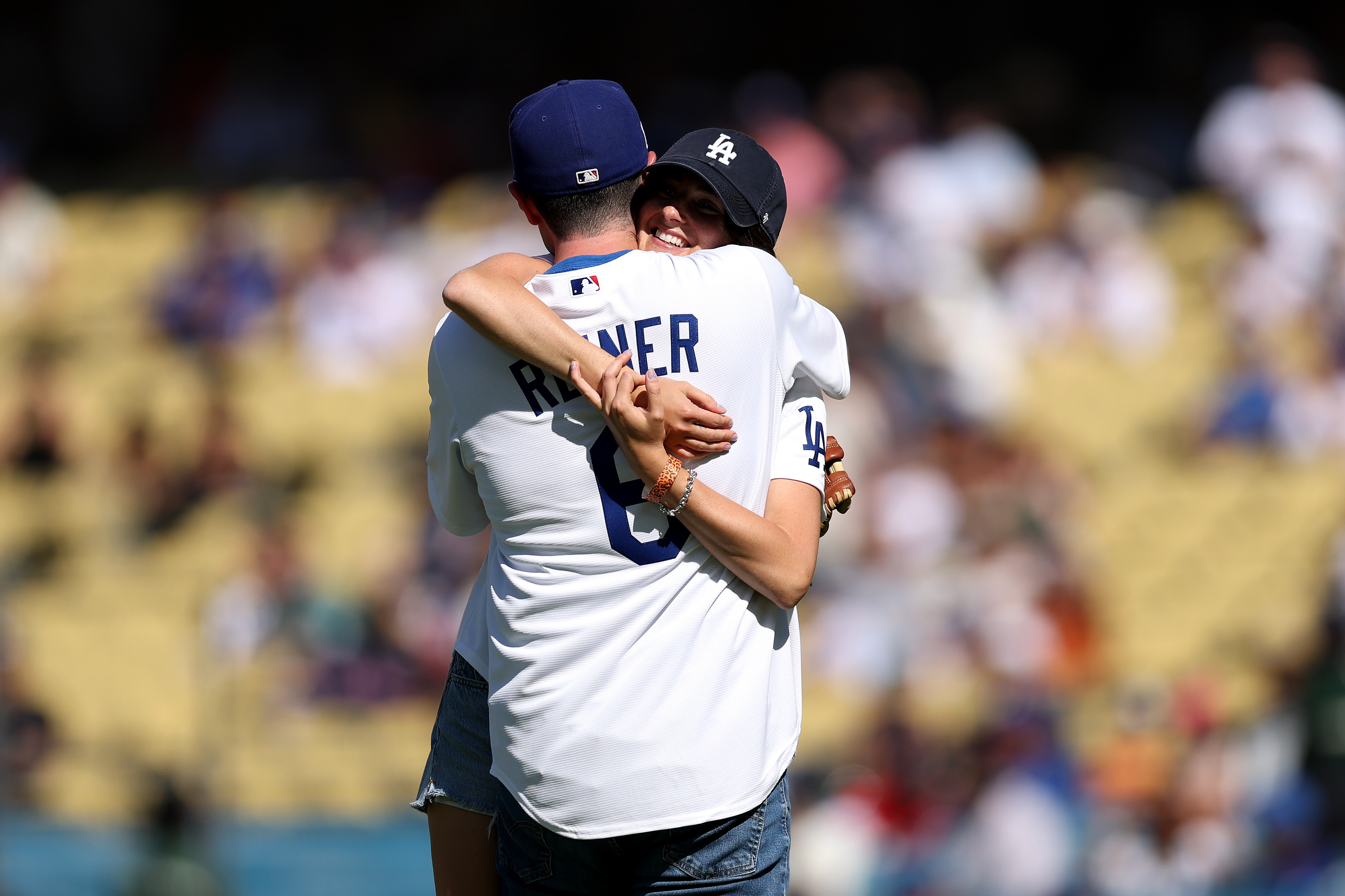 Jake Reiner and Romy Reiner hugging on the field at Dodger Stadium after throwing the ceremonial first pitch