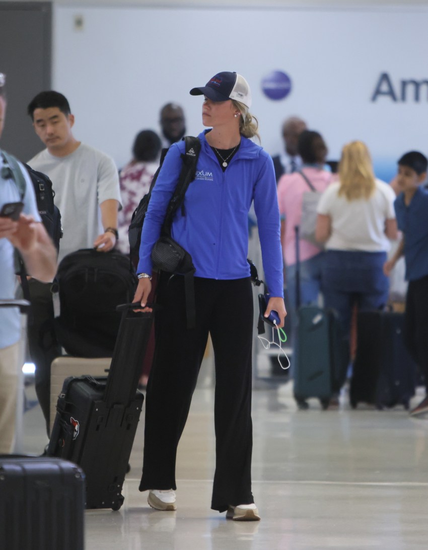 Ashleigh Scully walking through LAX with a Pelican camera gear case
