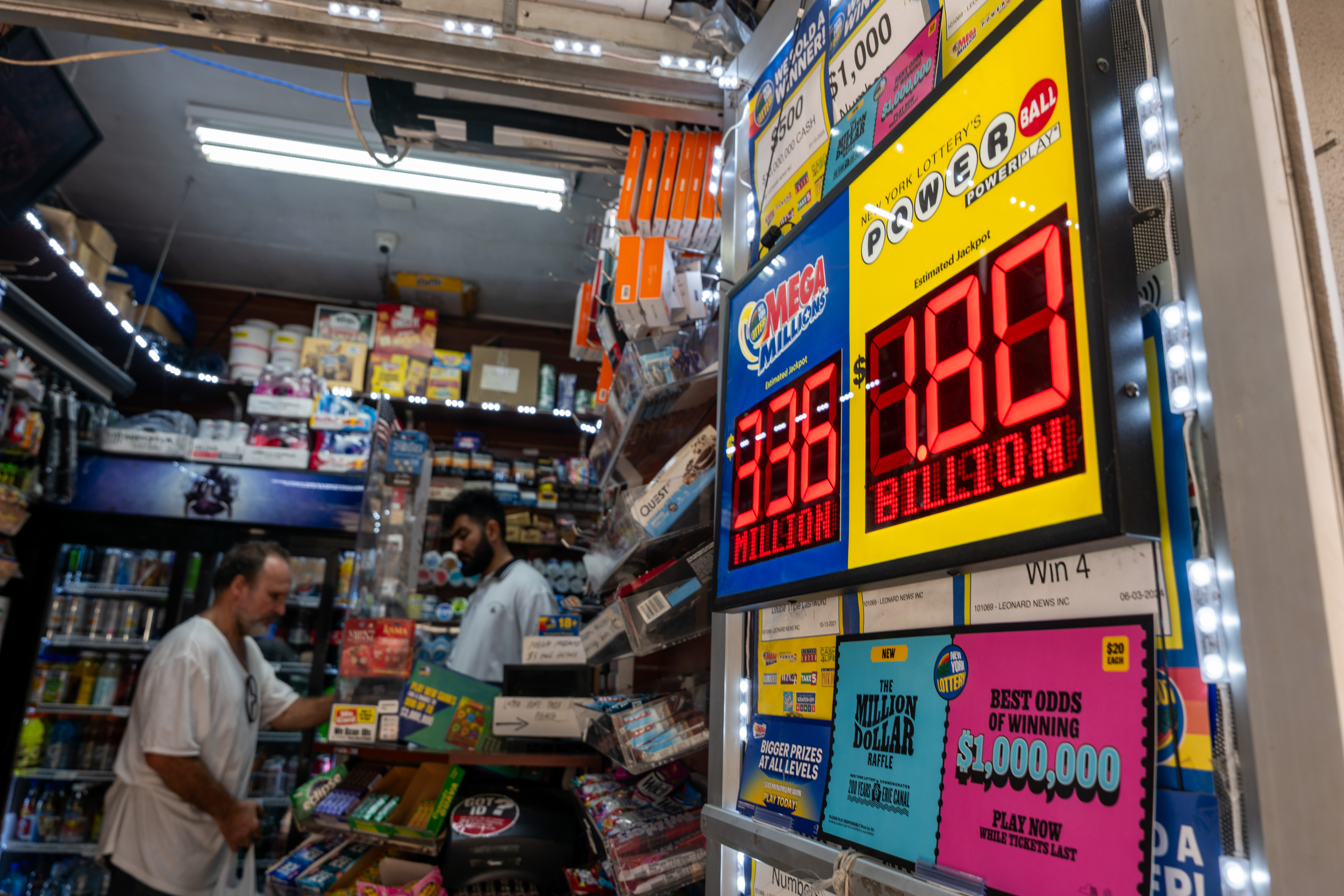 A newsstand in Manhattan with a Powerball jackpot advertisement showing $1.8 billion