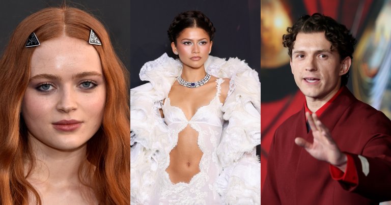 Sadie Sink with long auburn hair and Prada triangle hair clips at a red carpet event against a dark backdrop.