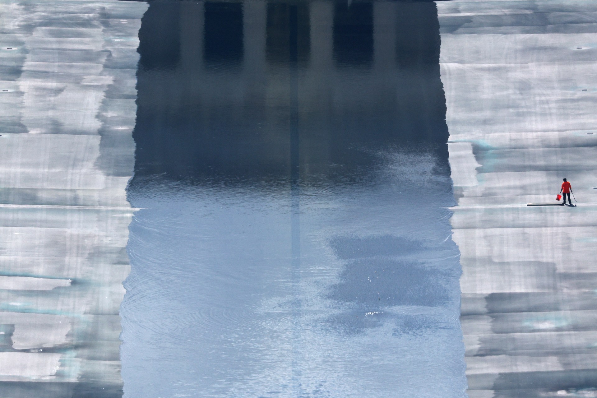 A lone worker at the partially filled Lincoln Memorial Reflecting Pool in Washington, D.C., August 2026