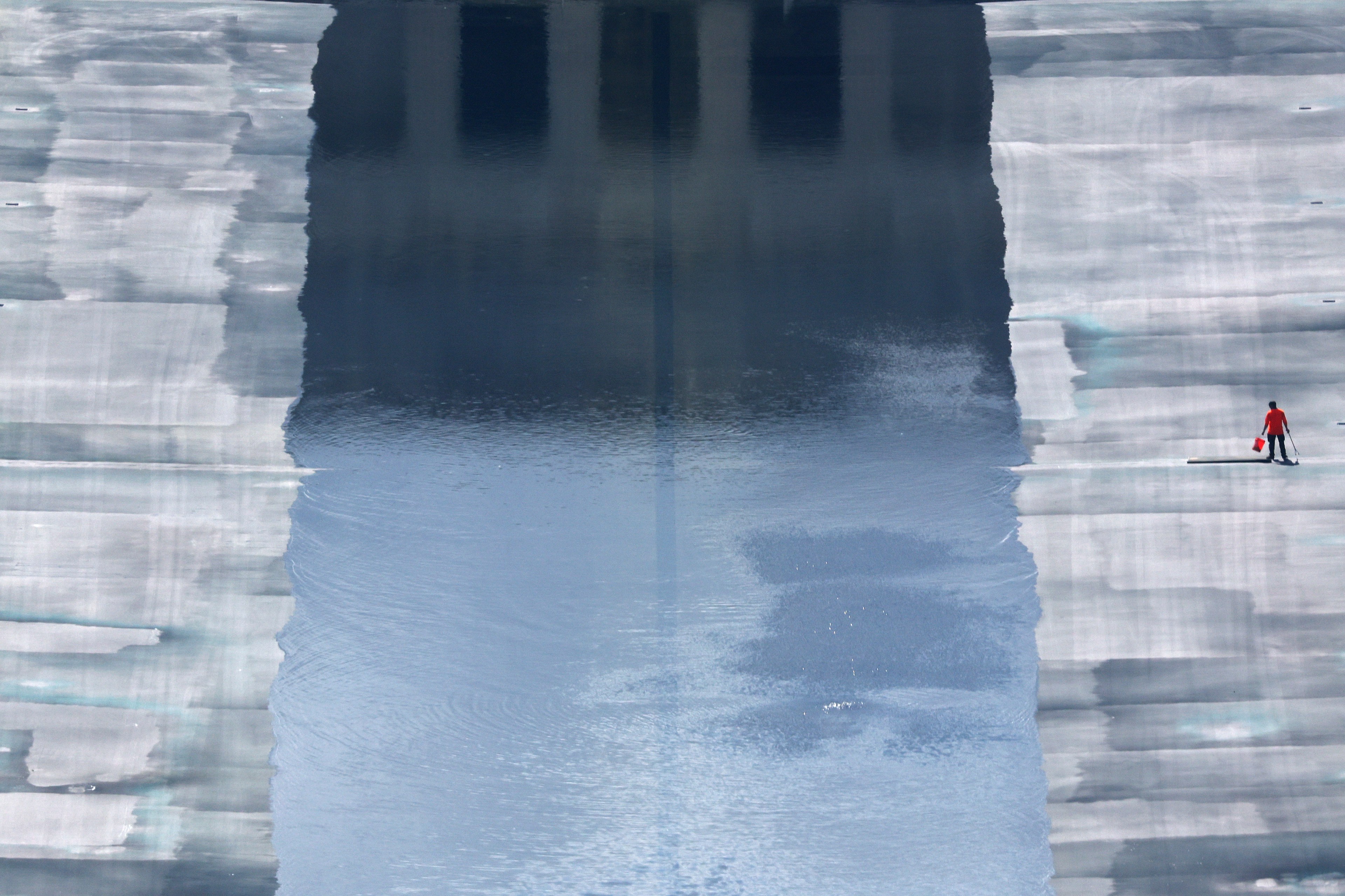 A lone worker at the partially filled Lincoln Memorial Reflecting Pool in Washington, D.C., August 2026