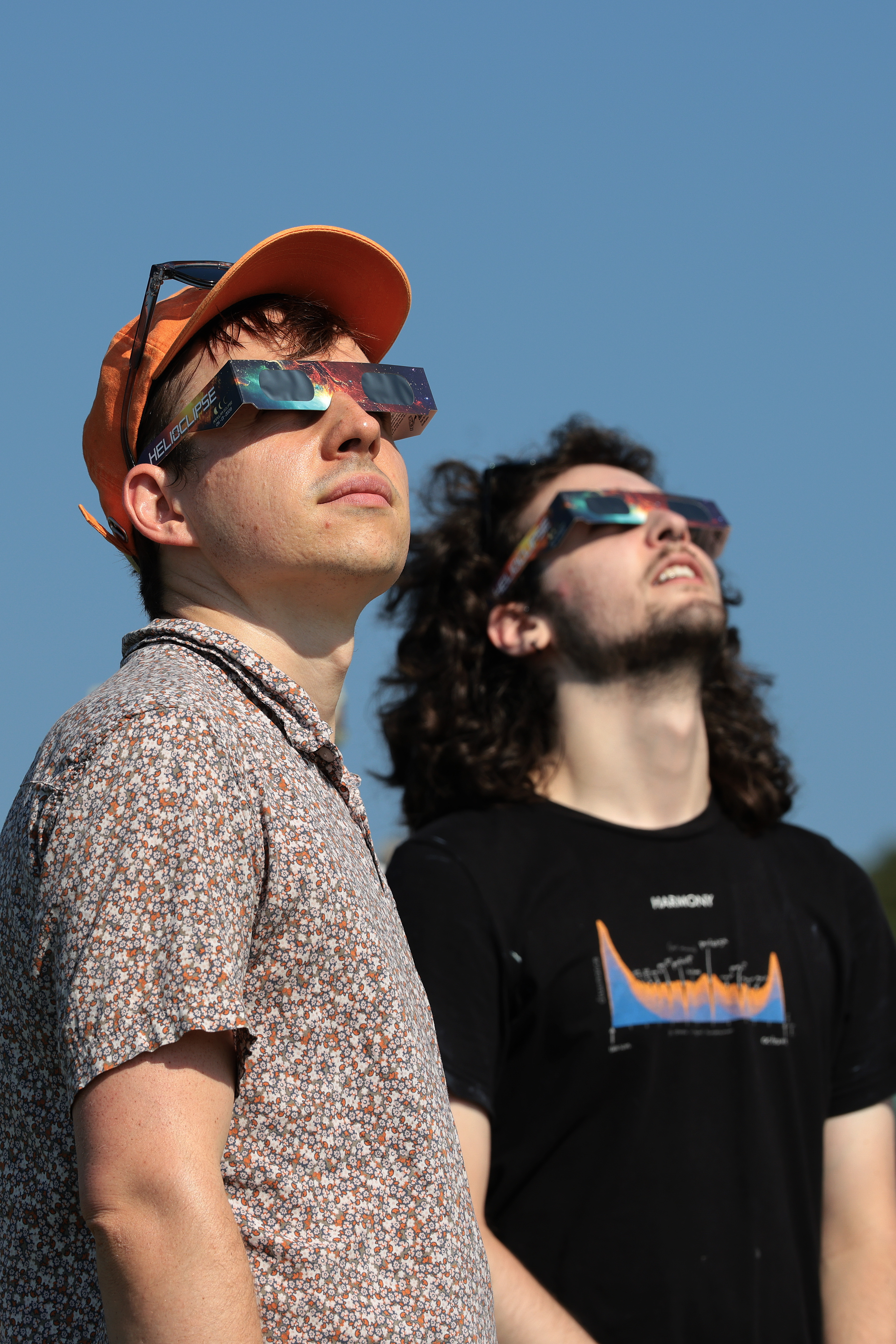 Crowd wearing solar eclipse glasses waiting at El Monte de San Pedro park in A Coruña, Spain