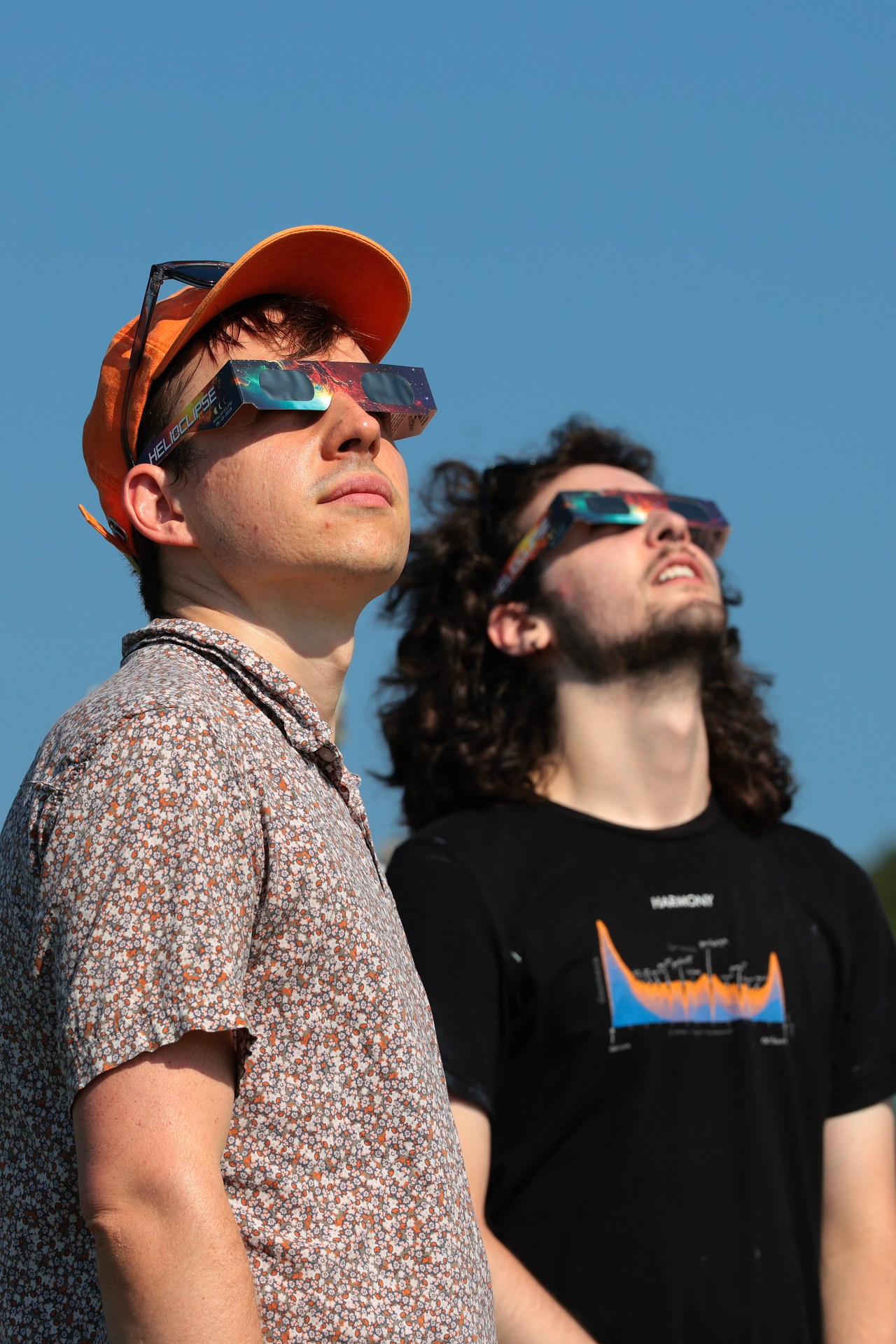 Crowd wearing solar eclipse glasses waiting at El Monte de San Pedro park in A Coruña, Spain