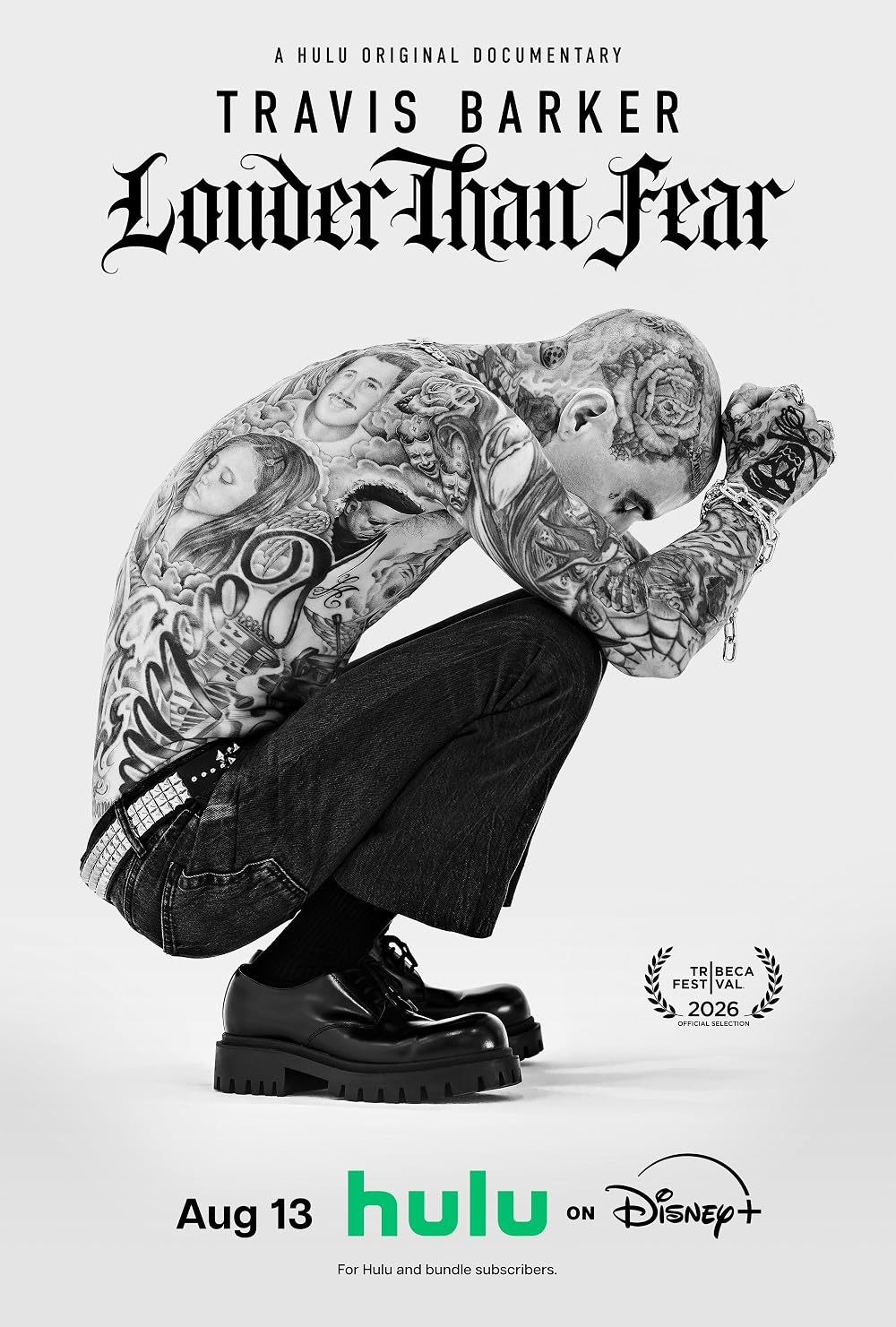 Black and white documentary poster showing a shirtless heavily tattooed man crouching with head down, title reading Travis Barker: Louder Than Fear, Hulu on Disney+, Aug 13.