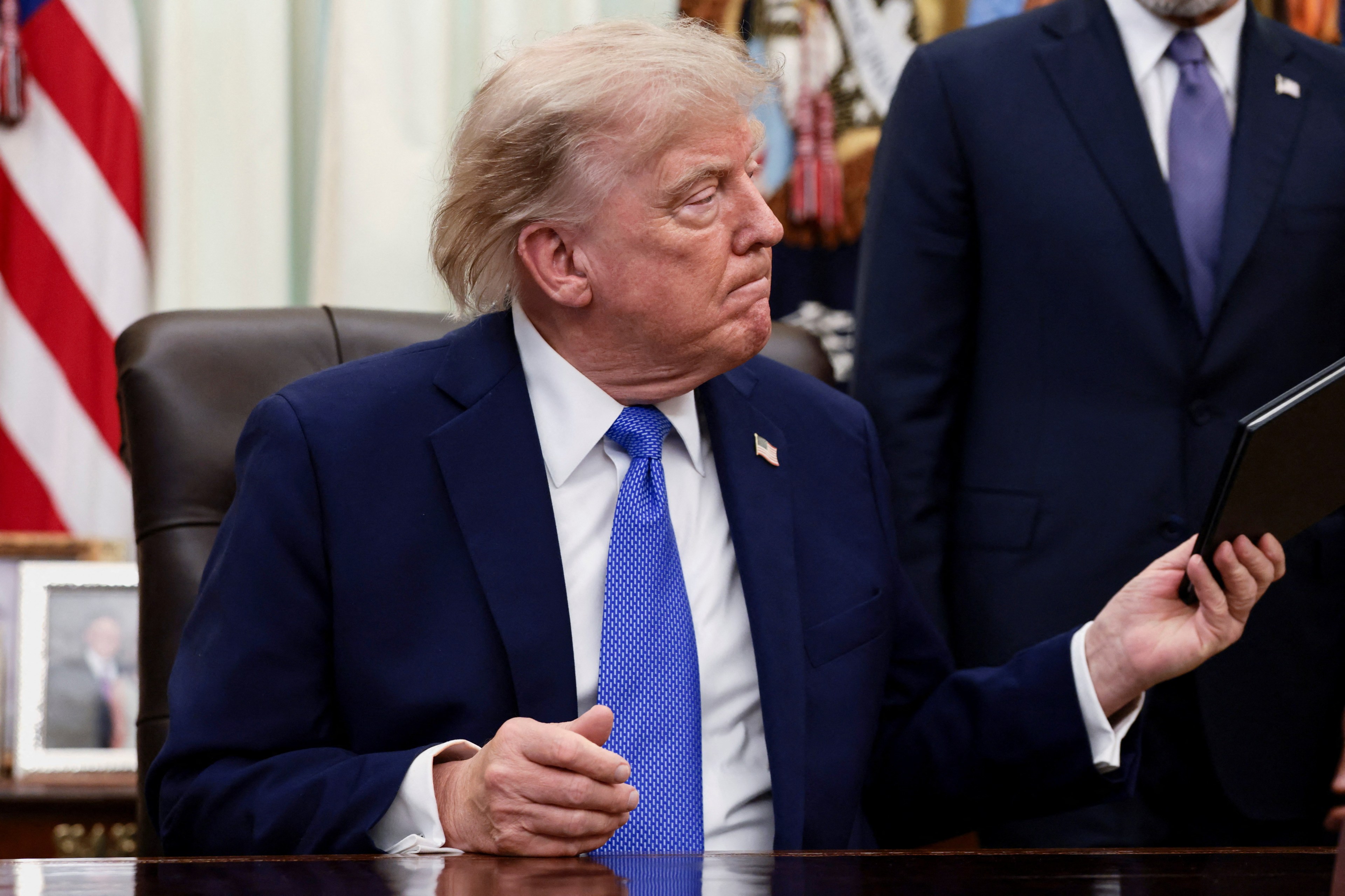 President Donald Trump signing executive orders at the Oval Office desk on August 6, 2026