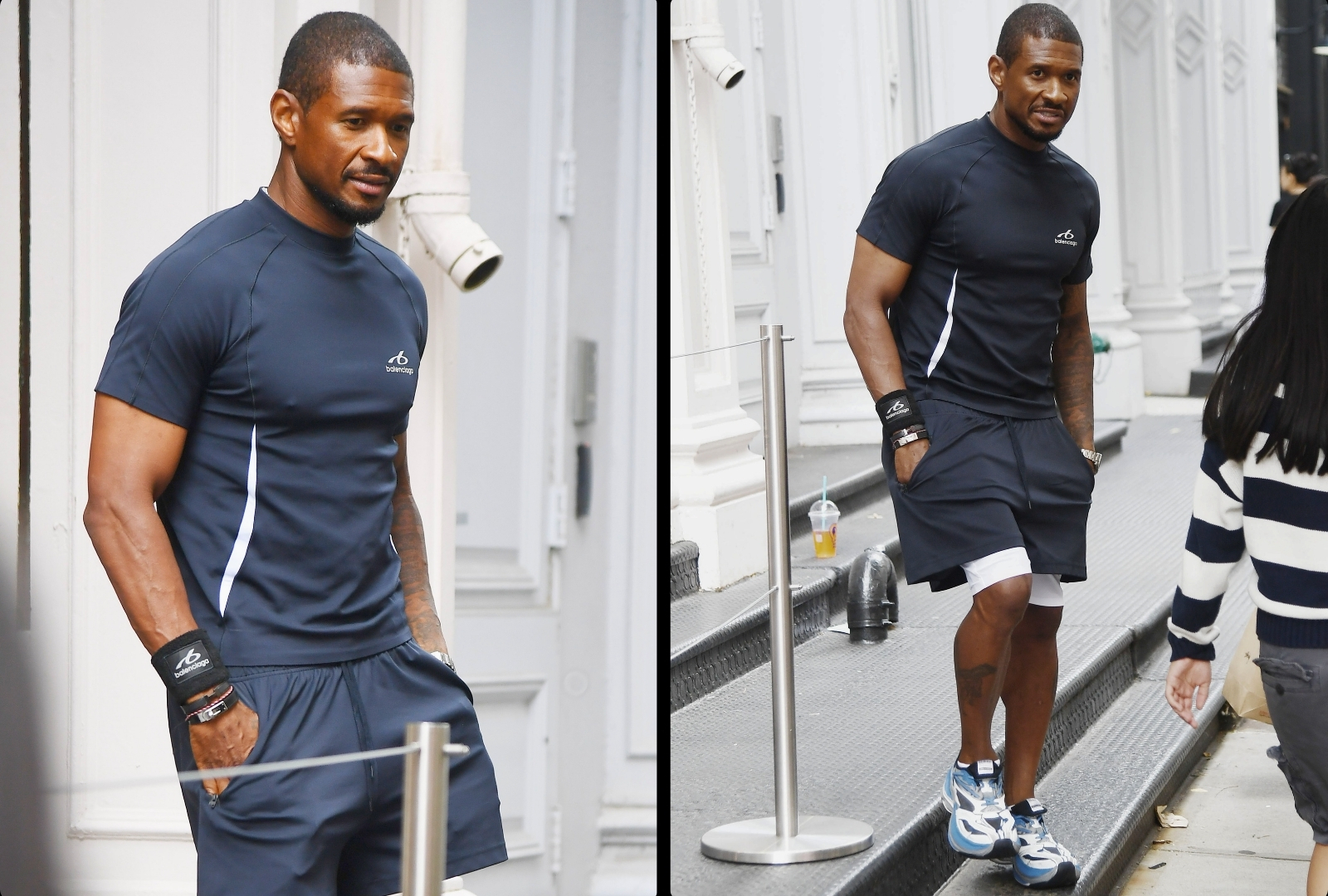 Man in navy Balenciaga athletic t-shirt, shorts, and black wristbands standing outdoors in SoHo, New York City.