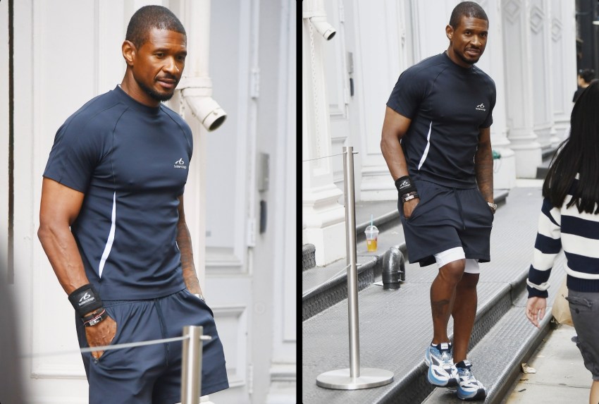 Man in navy Balenciaga athletic t-shirt, shorts, and black wristbands standing outdoors in SoHo, New York City.