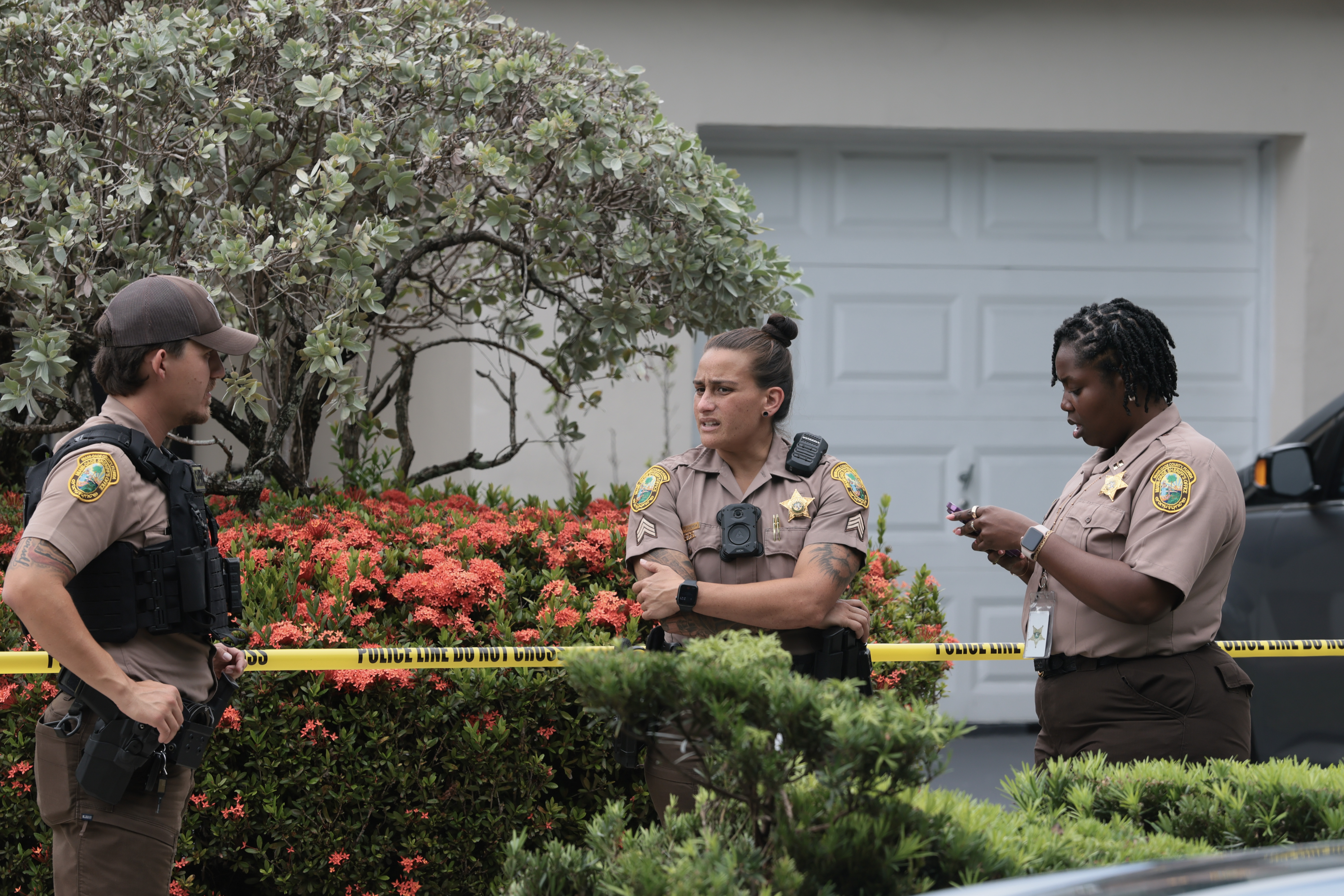 Miami-Dade County Sheriff's deputies standing outside a home in Westchester, Florida