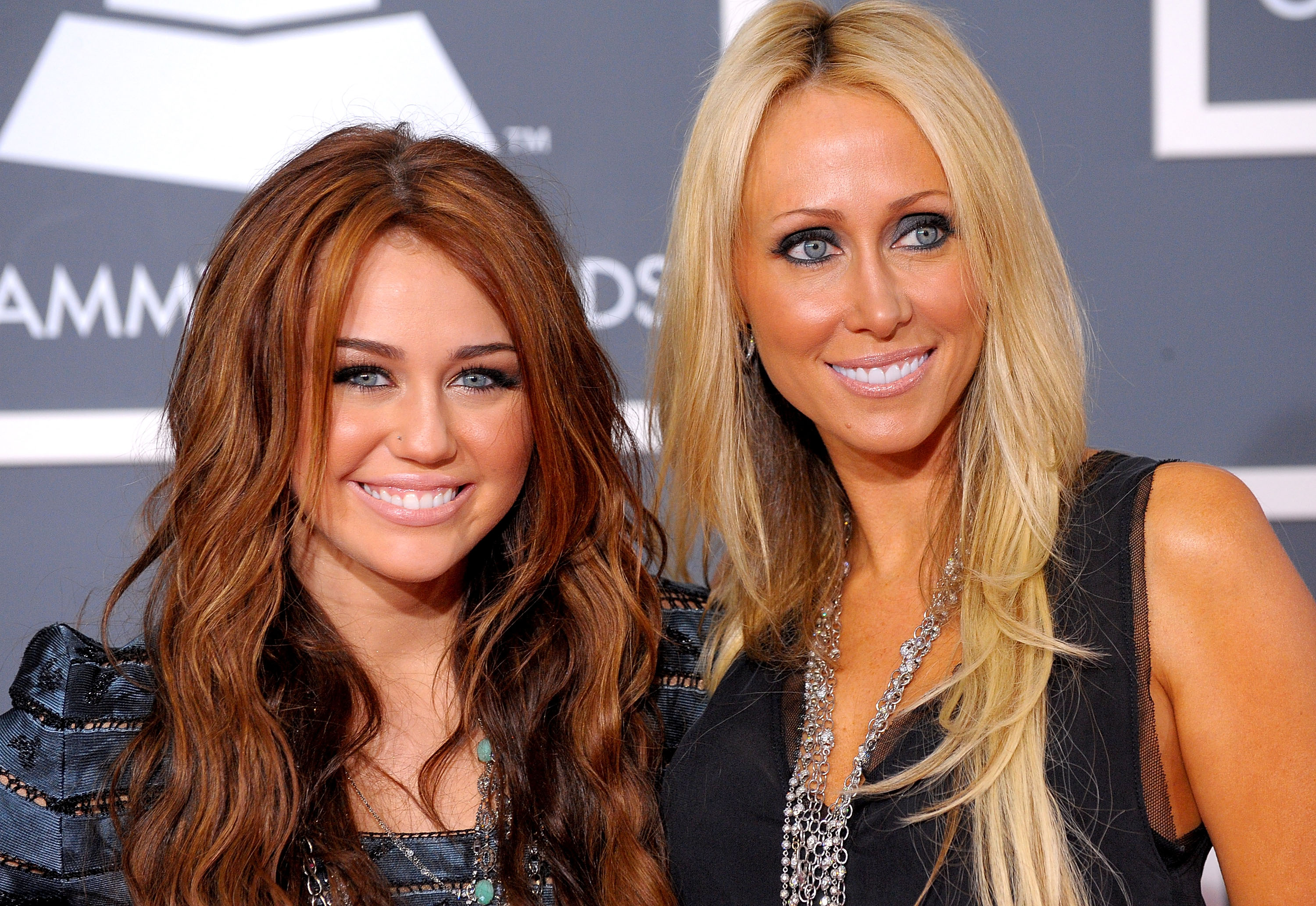 Miley Cyrus and her mother Tish Cyrus smiling on the red carpet at the 52nd Annual Grammy Awards, Los Angeles, 2010.