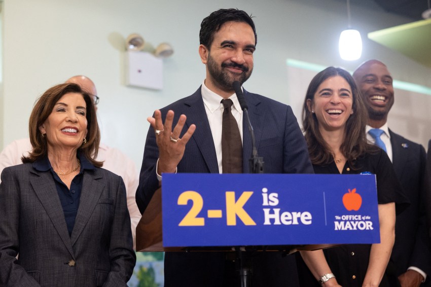 Zohran Mamdani and Kathy Hochul standing at a podium during a news conference in New York City