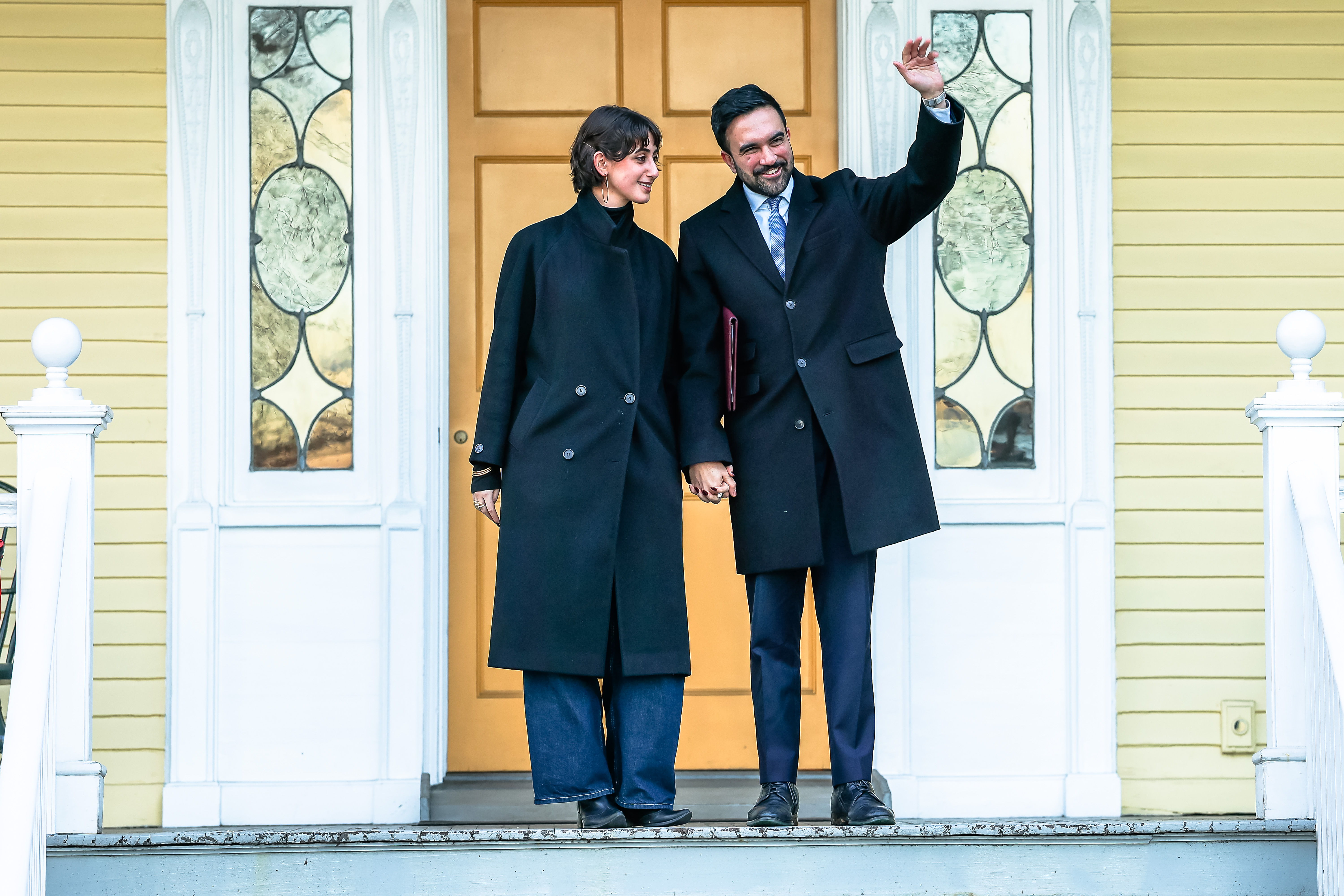 Zohran Mamdani and Rama Duwaji posing for photos at Gracie Mansion on moving day