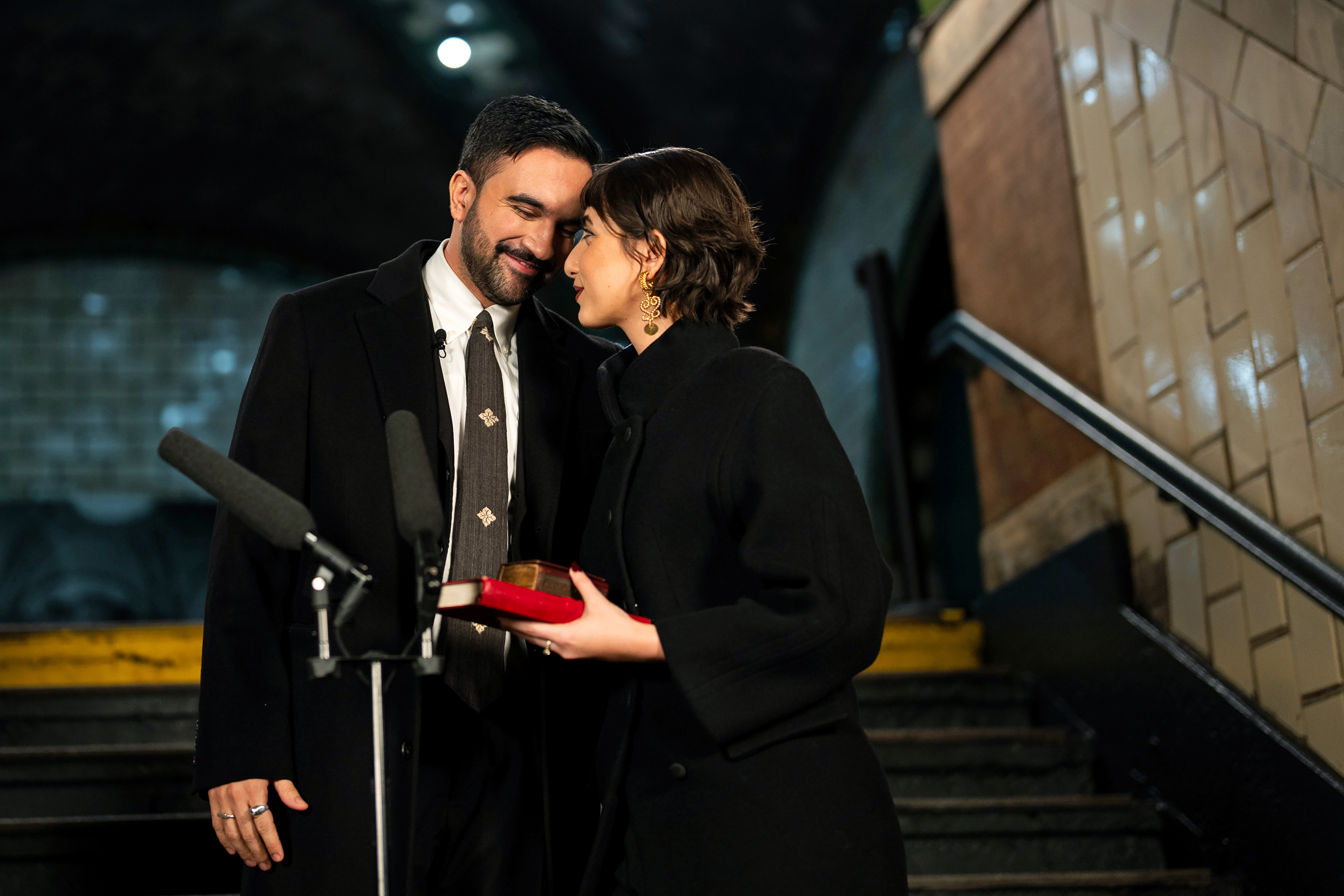 Zohran Mamdani and Rama Duwaji share a moment at his mayoral swearing-in ceremony at the former City Hall subway station in New York City
