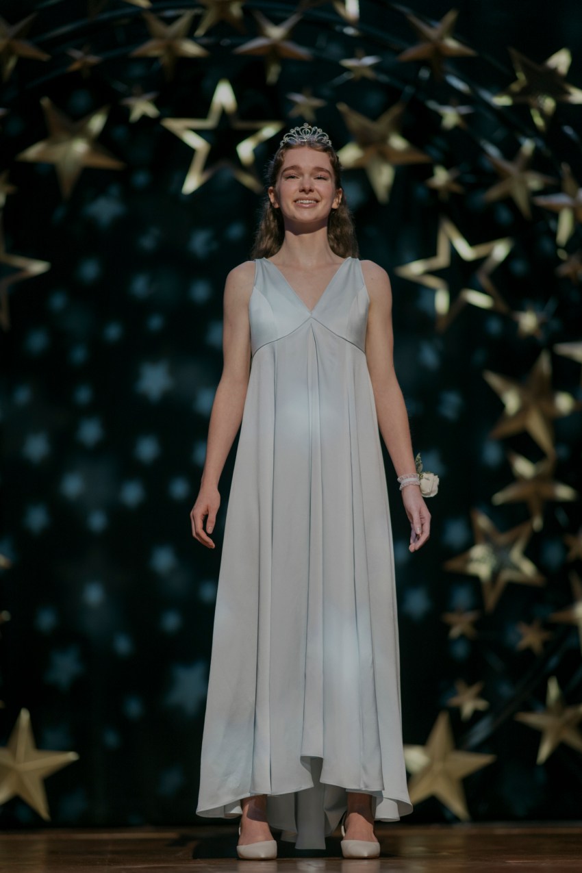Carrie White on stage in a white gown and tiara